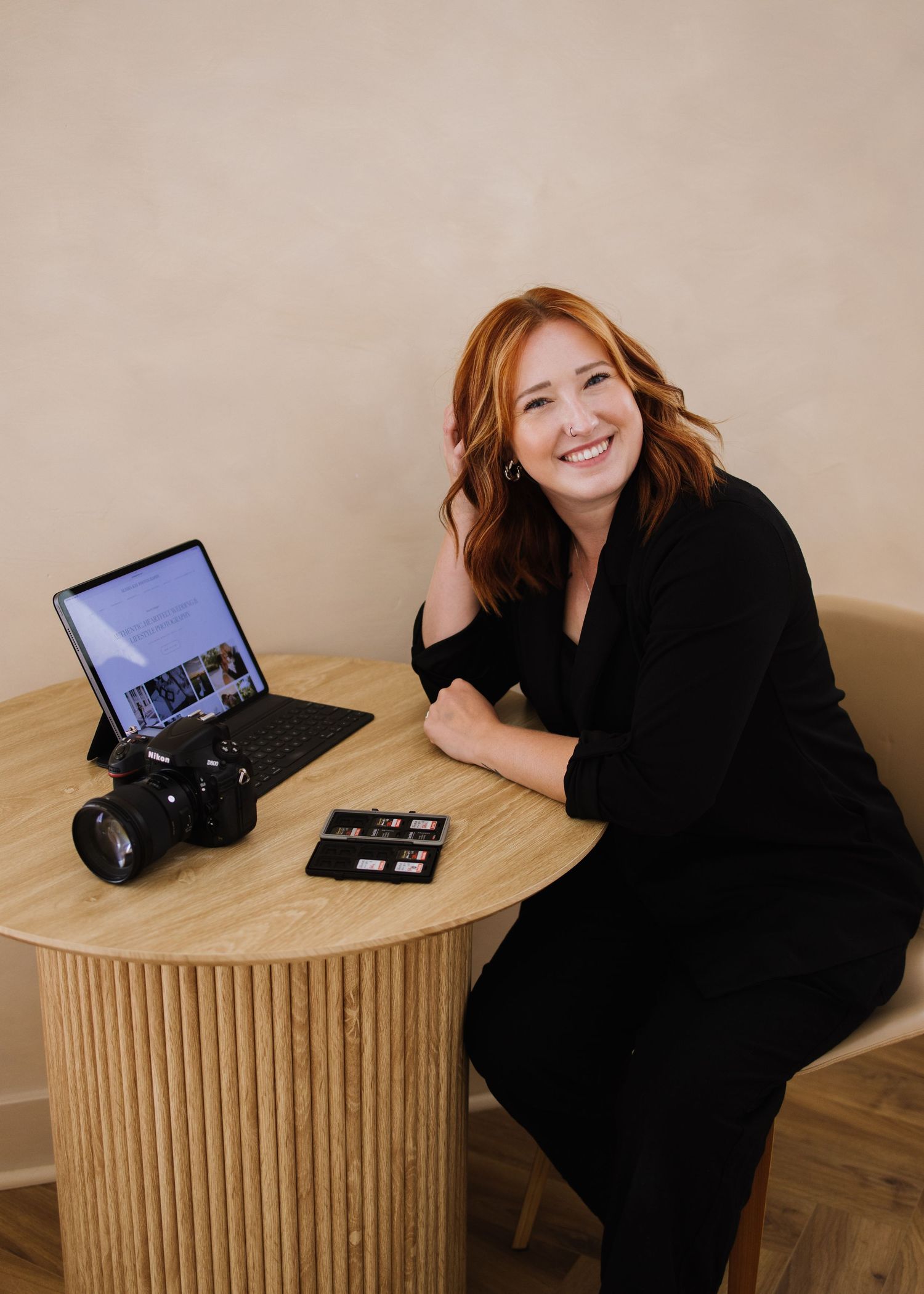 A sequence of photos showing a person in black attire posing with vintage camera equipment on a wooden table.