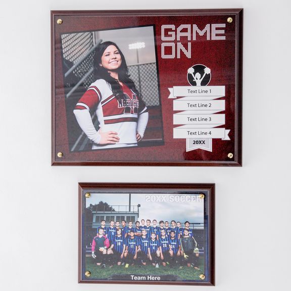 Collection of red and white sports team photo plaques mounted on a wall showing team photos and individual portraits.