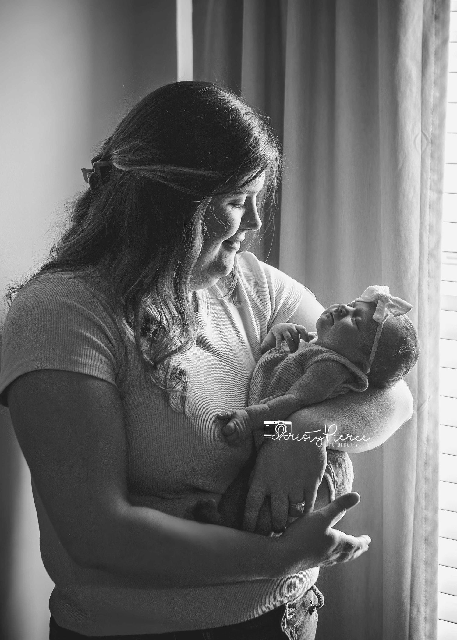 Four sequential black and white photos show a tender moment between a parent and small child near a window.