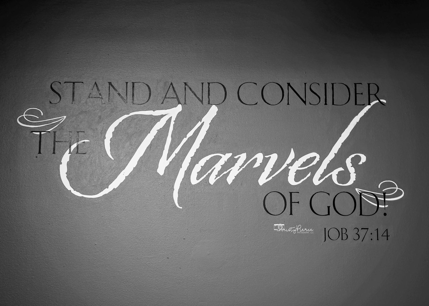 Black and white inspirational text reading 'Stand and Consider the Marvels of God - Job 37:14' in elegant typography.