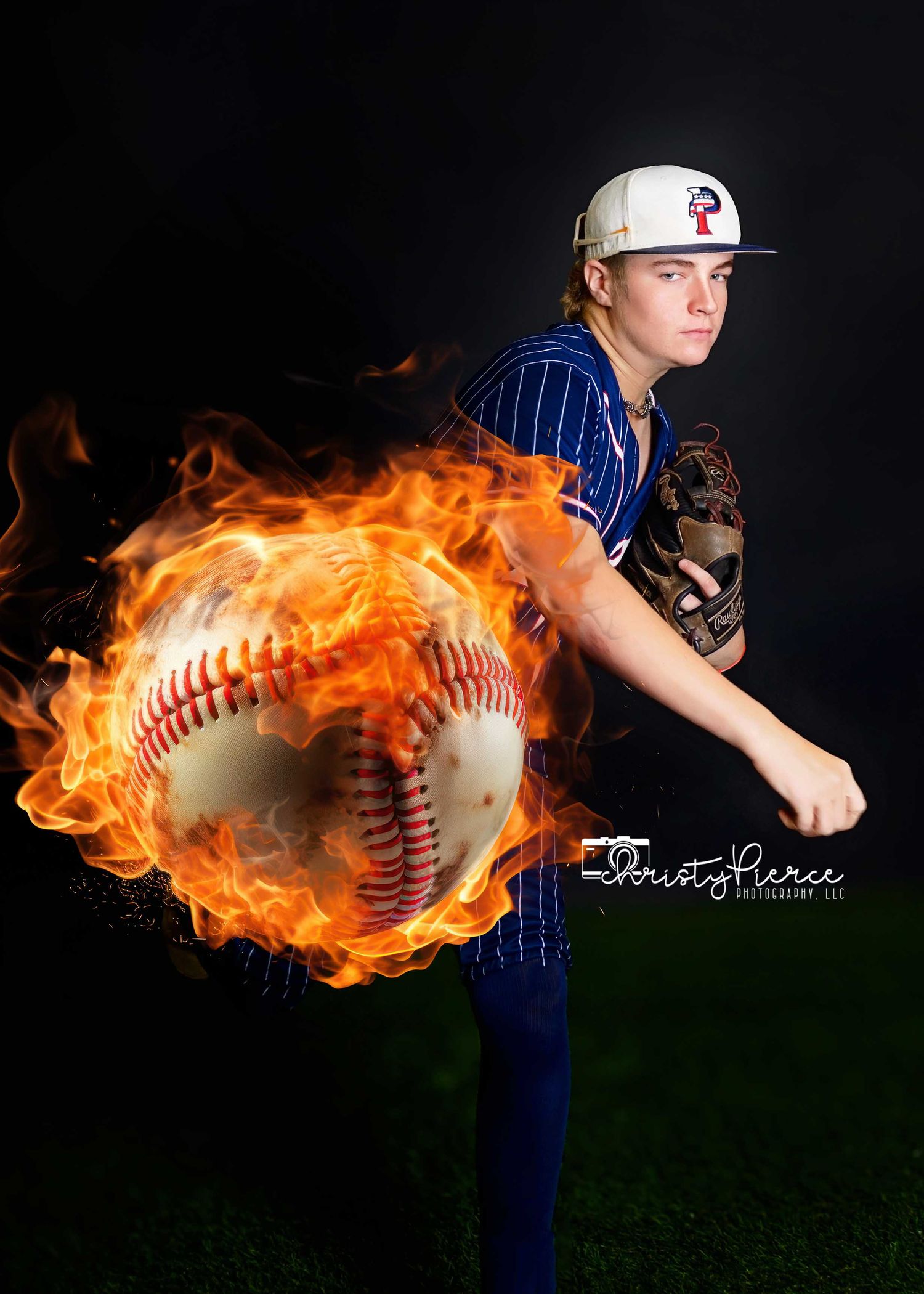 Baseball player in pinstripes throws pitch with dramatic flaming baseball effect in dark studio portrait.