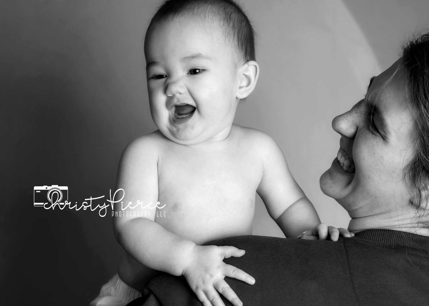 A tender black and white photo montage shows intimate moments between parent and baby during playtime.