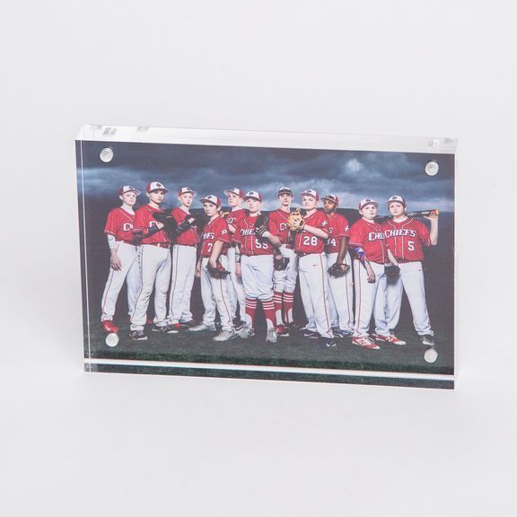 Panoramic team photos of baseball players in red and white uniforms mounted on wall.