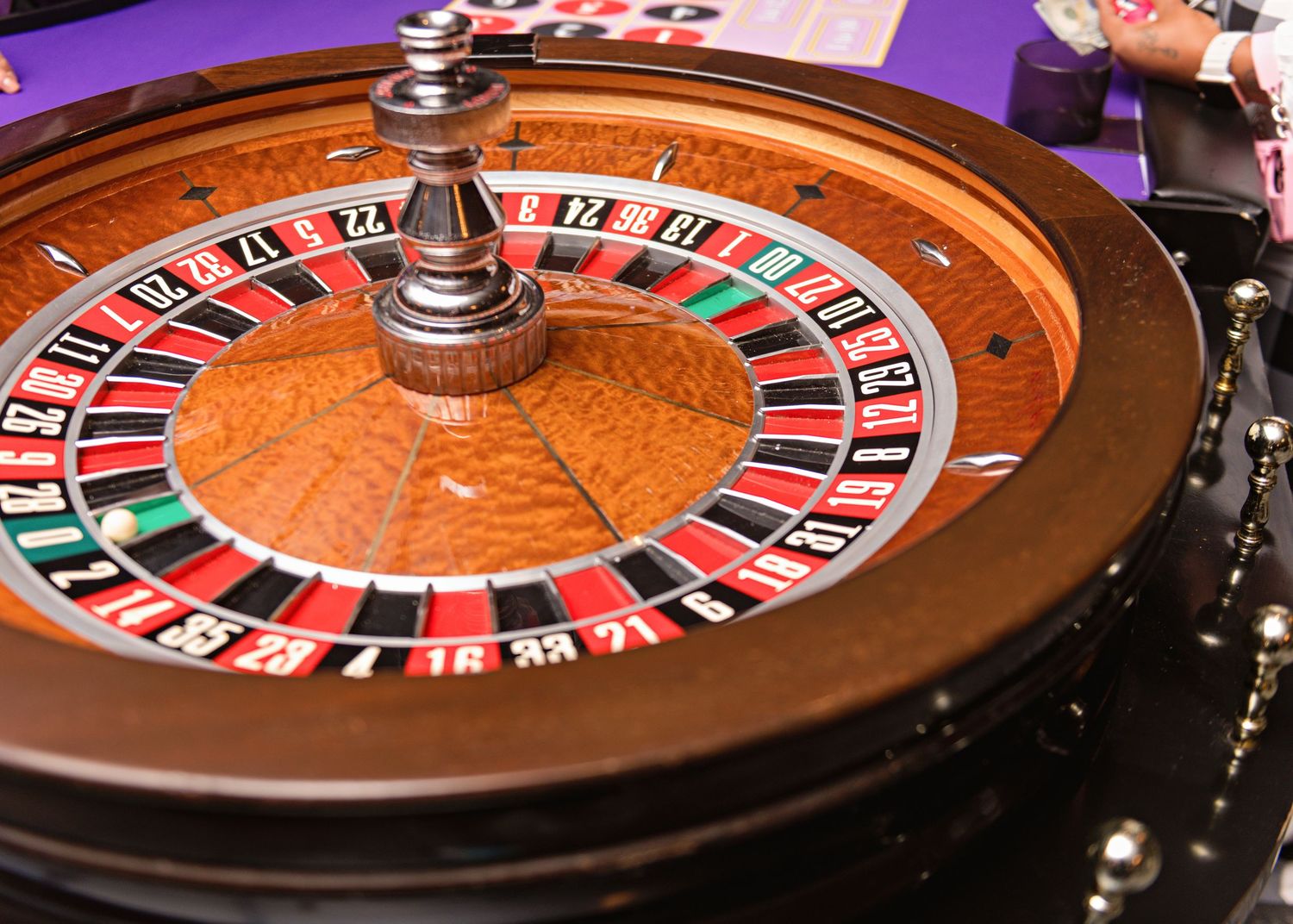 Close-up view of multiple casino roulette wheels with red and black numbers showing on the spinning surface.