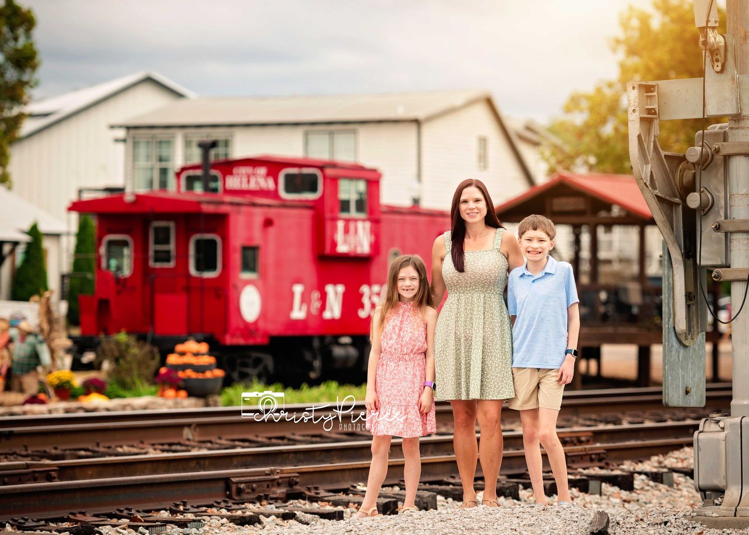 A collection of photos showing people posing near red train cars and railroad tracks at sunset.