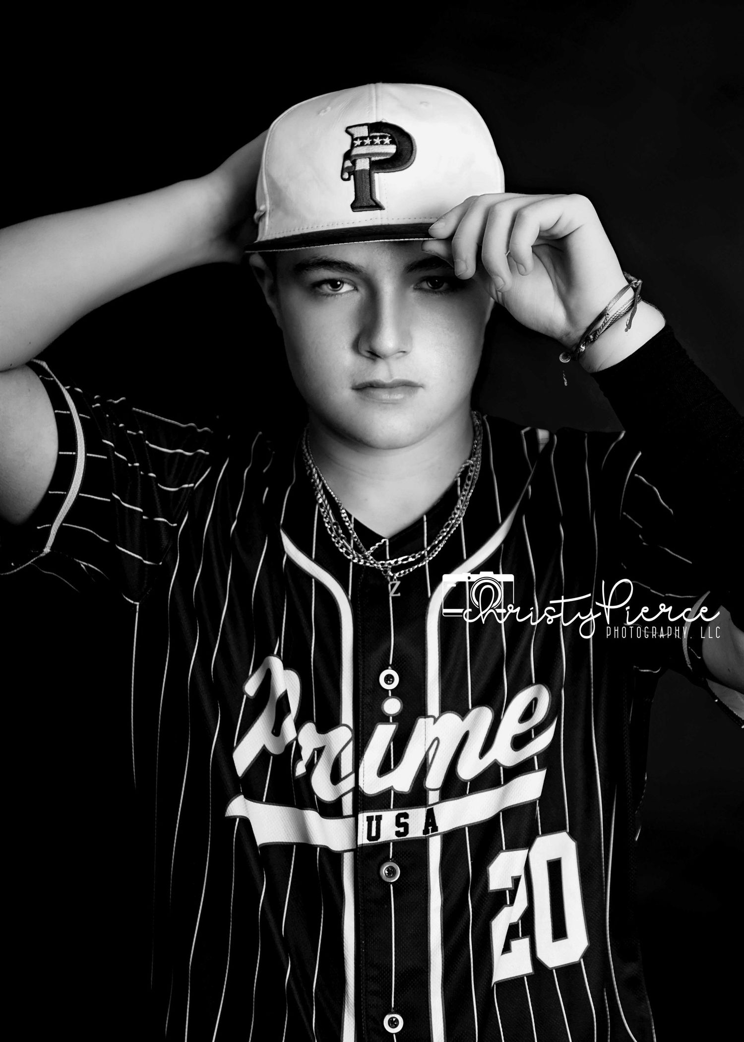 Black and white portrait of a baseball player wearing a pinstriped jersey and P logo cap in a classic sports pose.