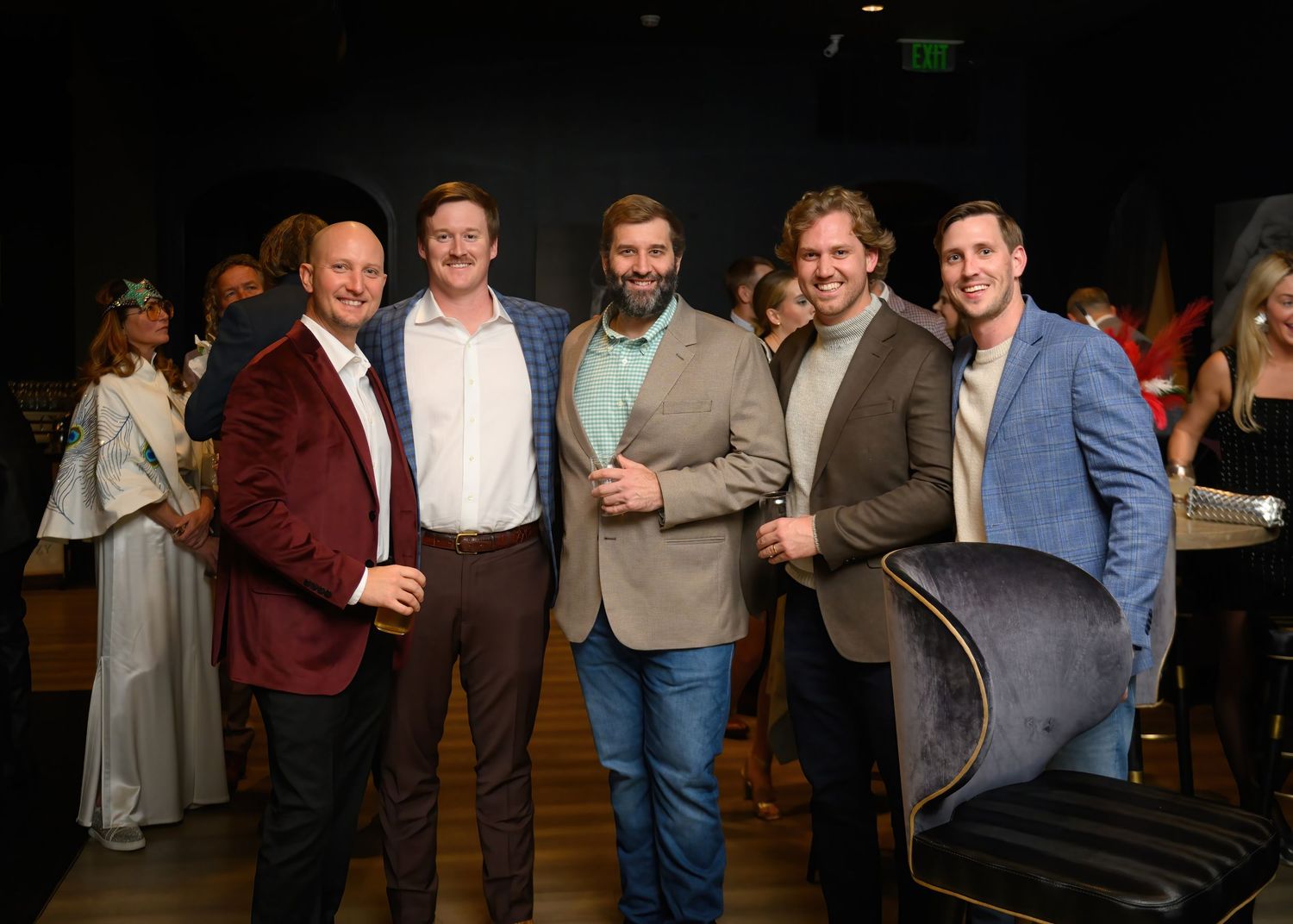 Group of people socializing and mingling at an indoor networking event or reception.