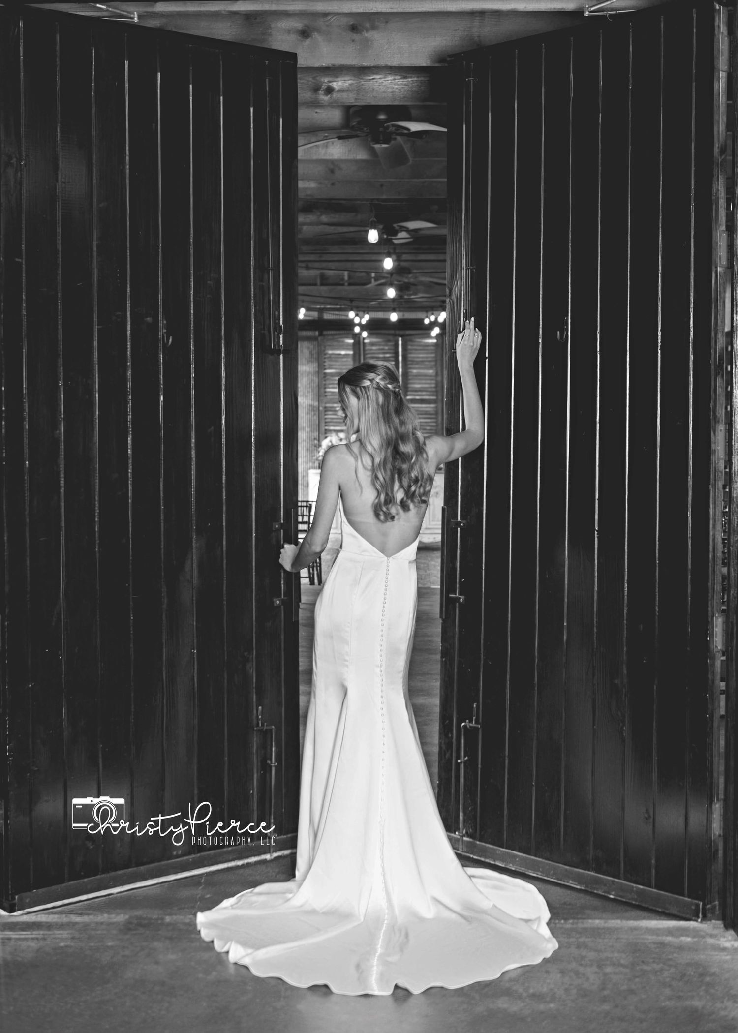 A black and white panoramic sequence shows a person in a flowing white dress posing dramatically against dark wooden walls.