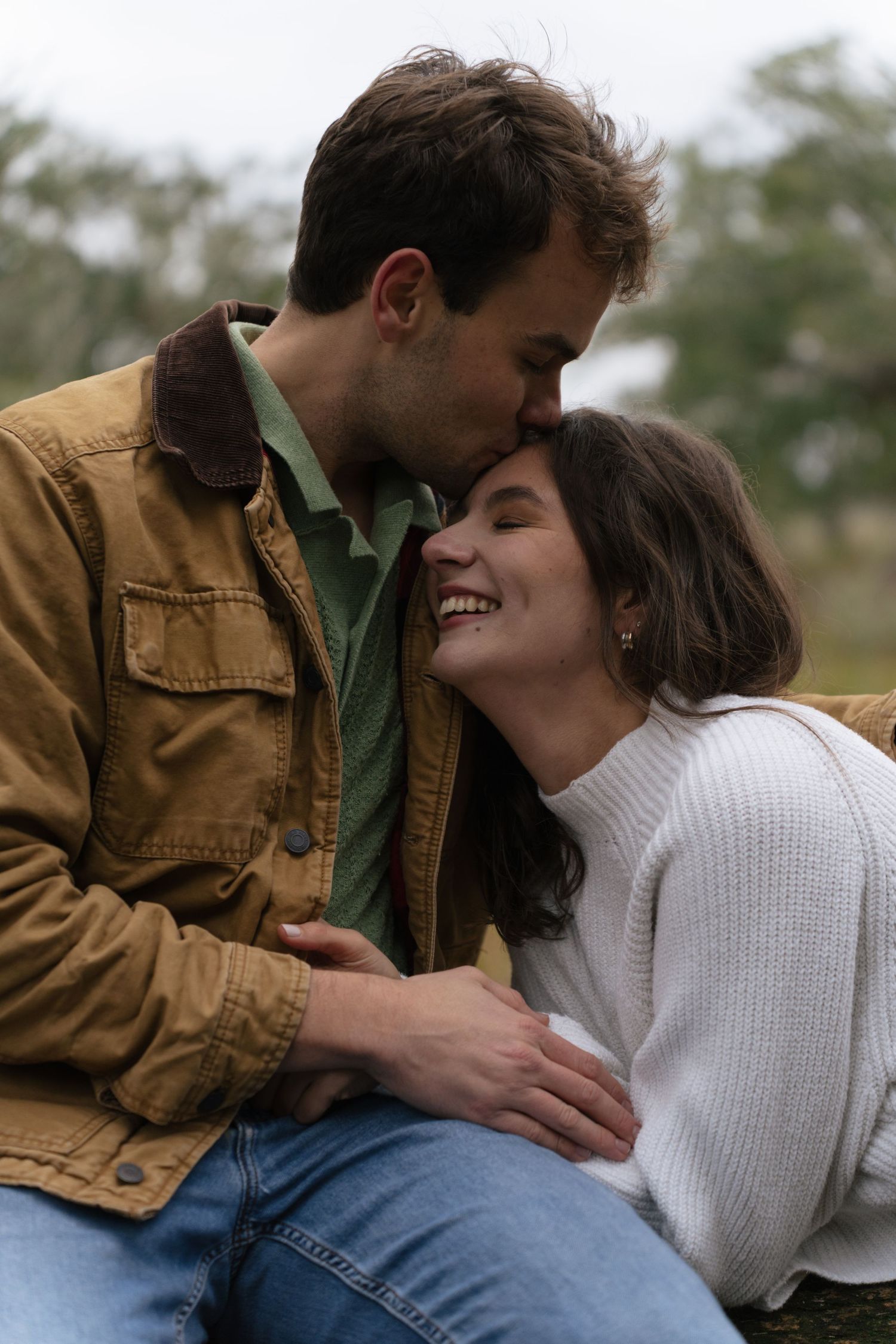 A couple in casual attire share intimate moments in a series of romantic outdoor photos.
