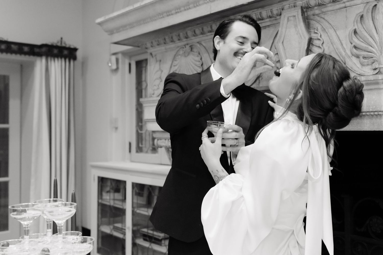 A series of black and white photographs showing a couple sharing intimate moments and kisses at their wedding celebration.