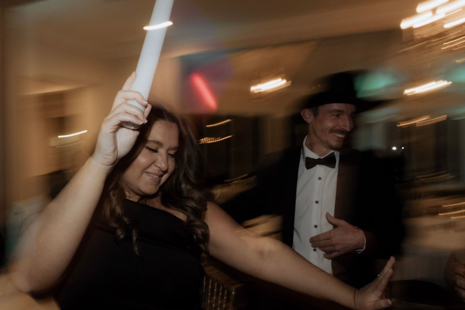 Motion blur photo capturing movement in dark indoor setting.