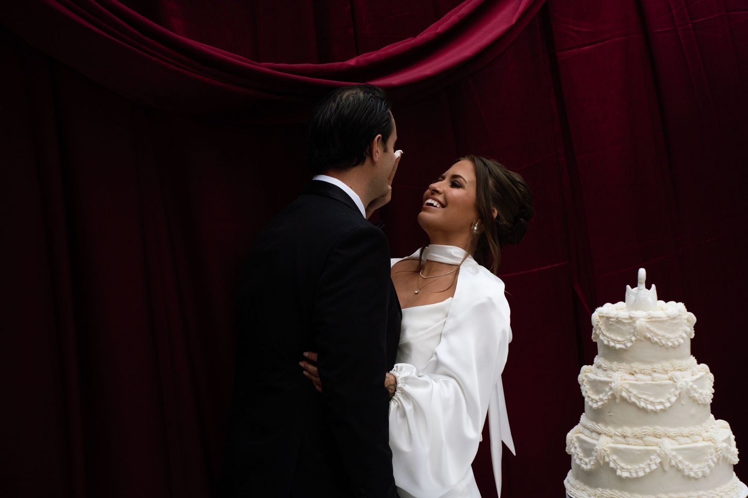A series of wedding photos showing romantic moments between newlyweds with a white tiered wedding cake.