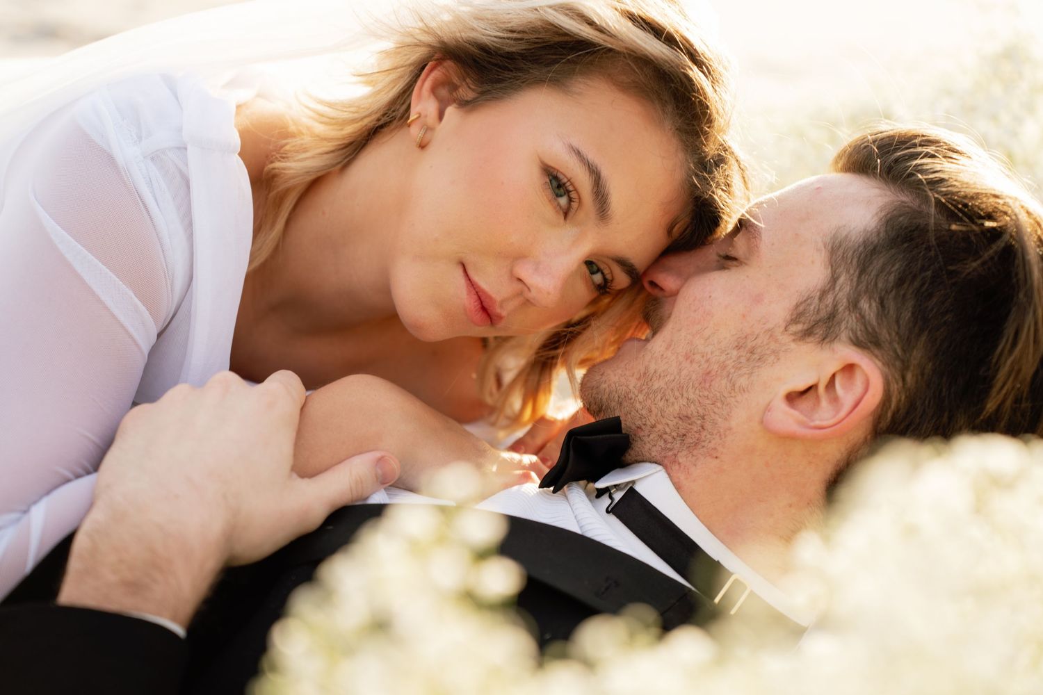 Romantic couple shares intimate moments in a series of dreamy backlit photos with soft natural lighting.