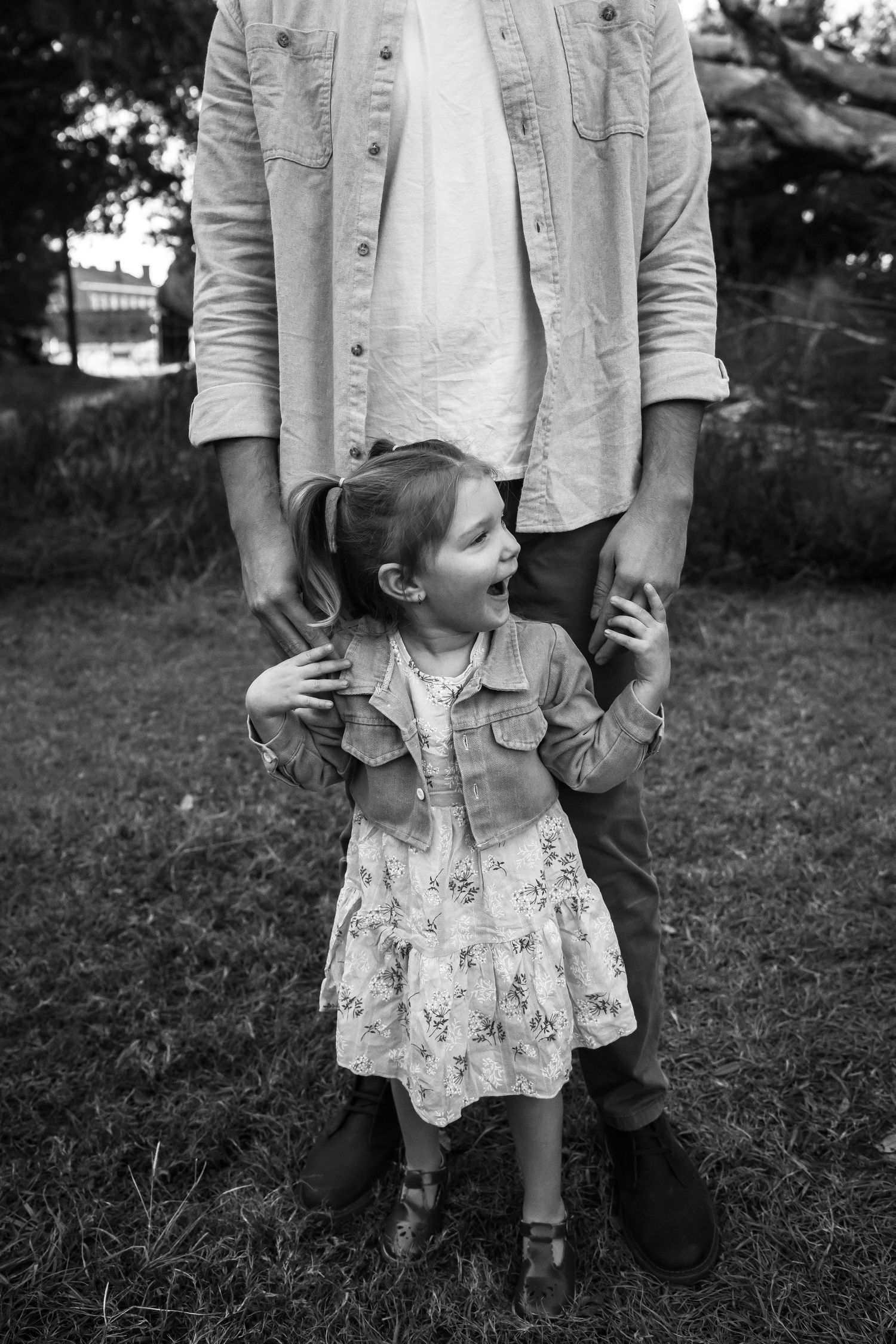 A loving black and white candid photo showing parental affection captured at Fort Clinch State Park