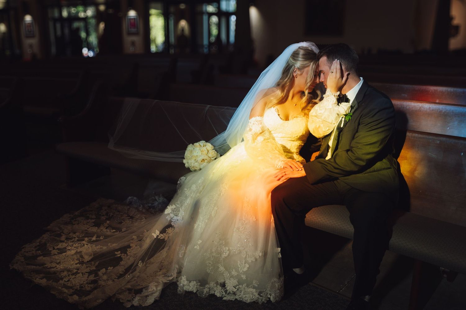 Romantic silhouettes of a bride and groom dancing together at night with dramatic lighting effects.