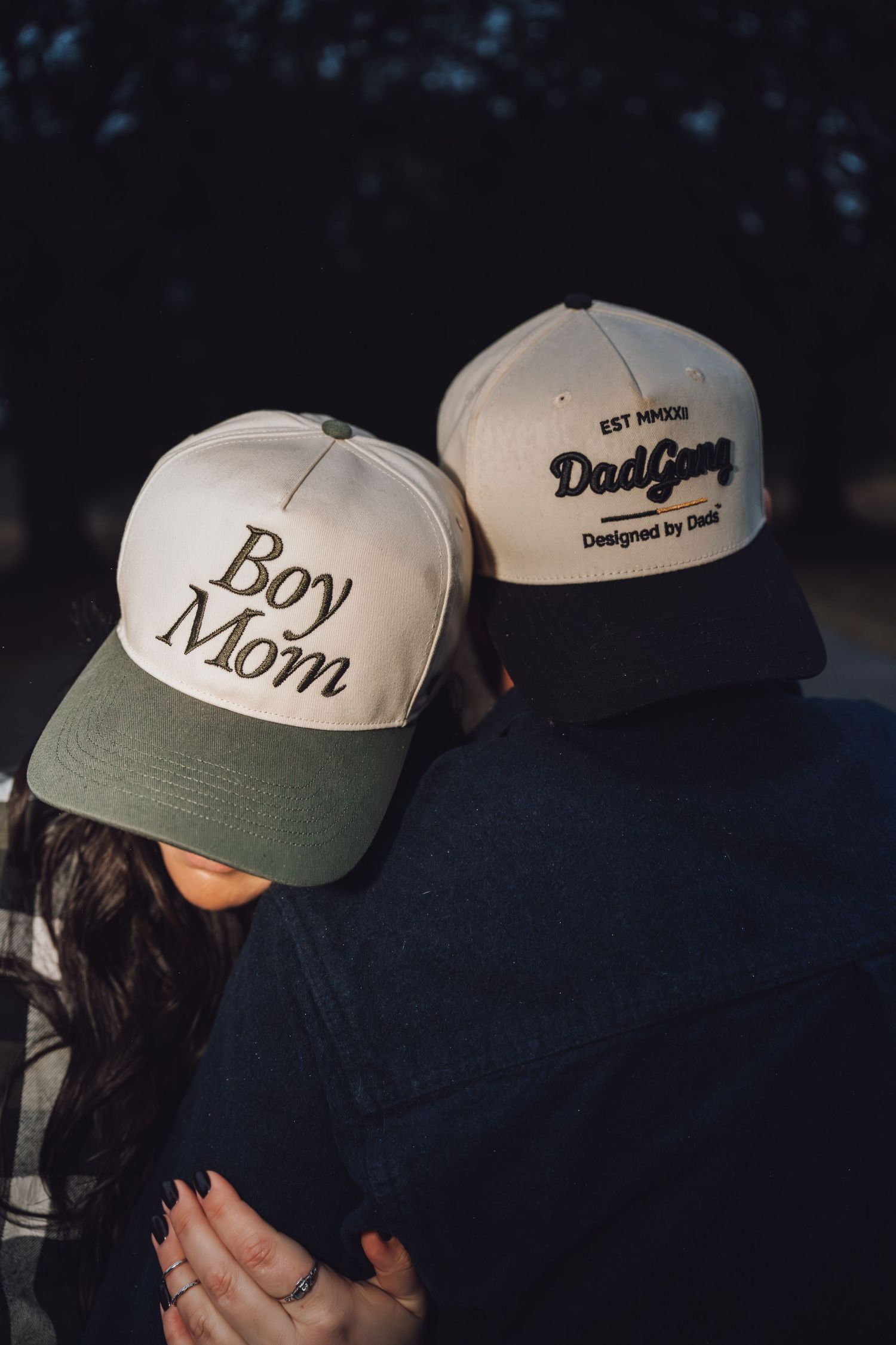 A series of matching baseball caps with white crowns and olive green brims shown from different angles.