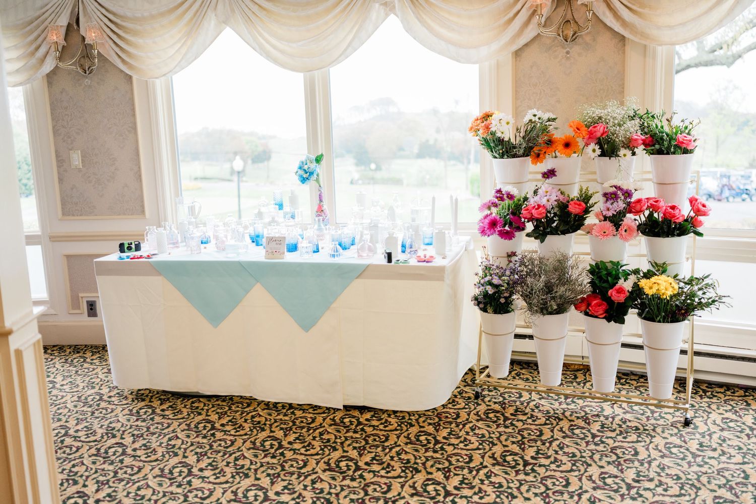 Elegant event space with draped windows and patterned carpet visible in panoramic view.