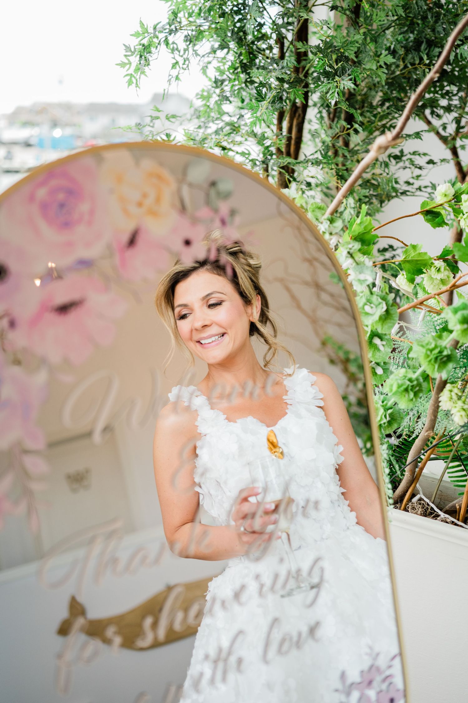 Elegant wedding decor with white dress and butterfly details in a garden setting.