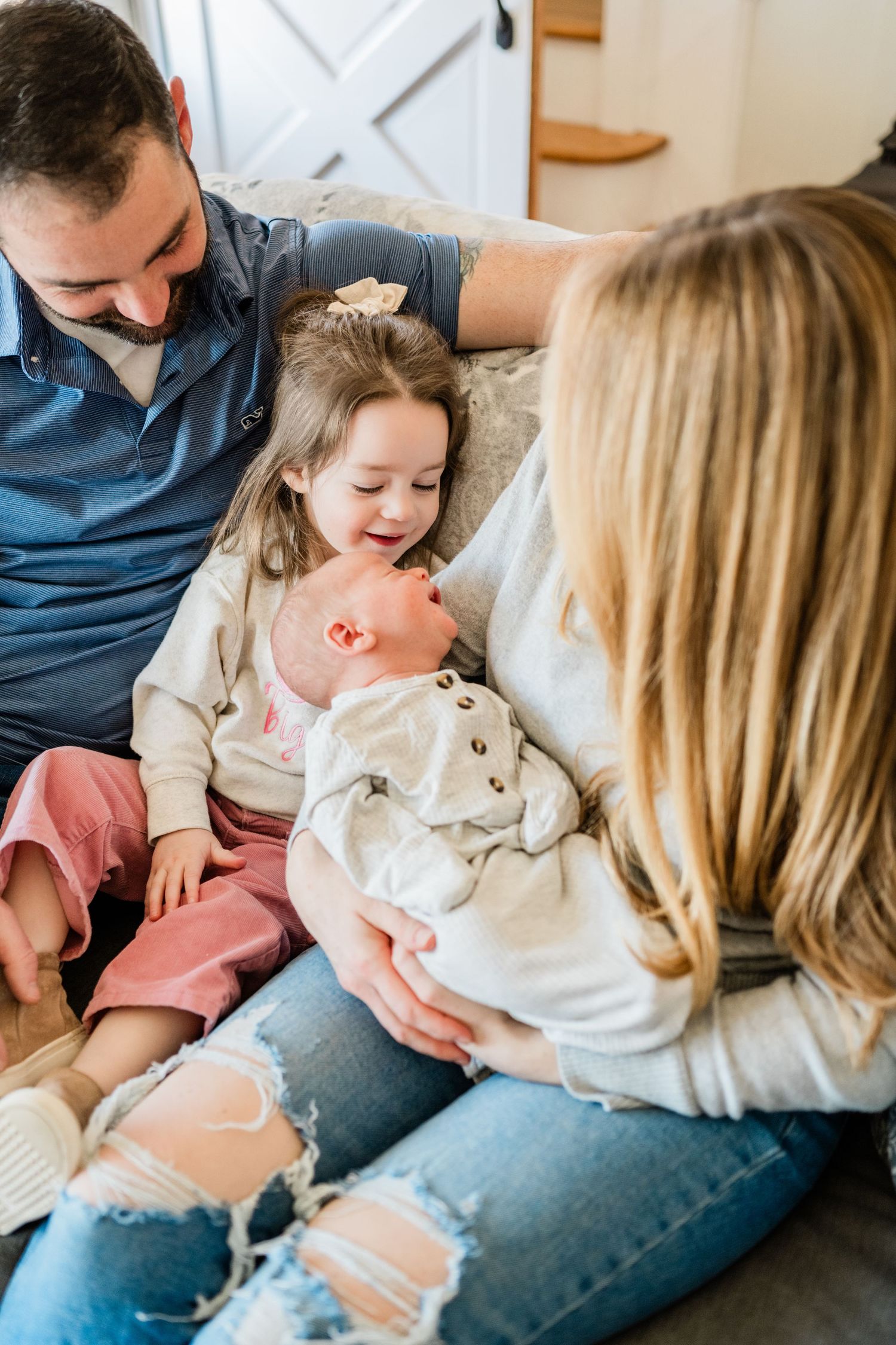 Family sharing a candid moment together on a couch.