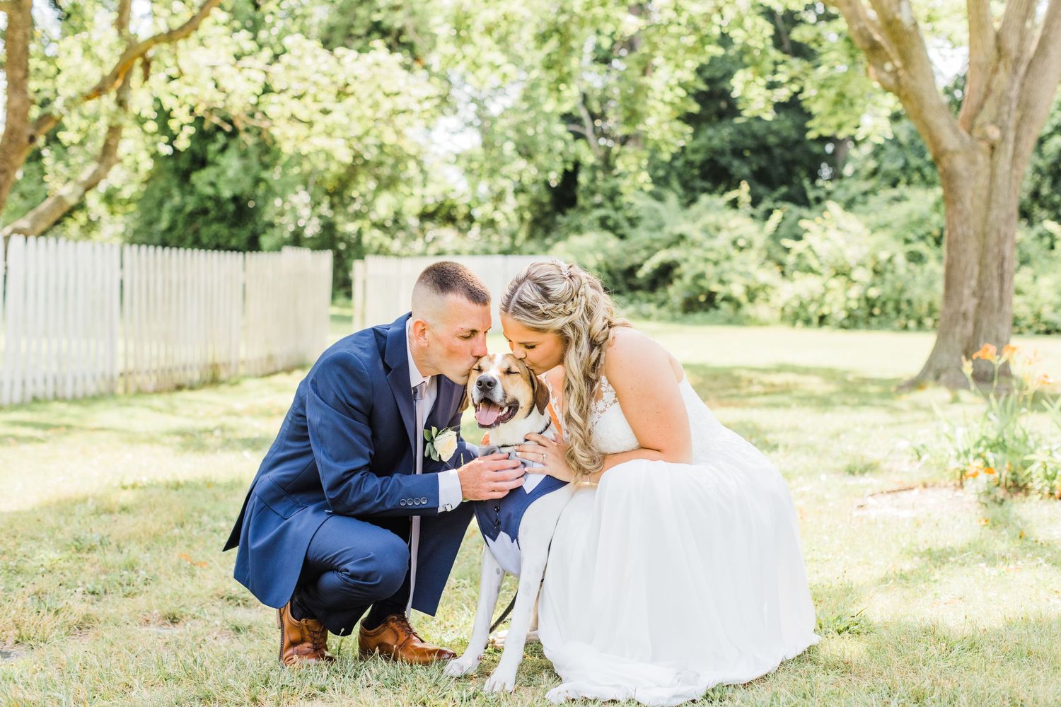 Couple sharing tender moments in sunny garden setting.