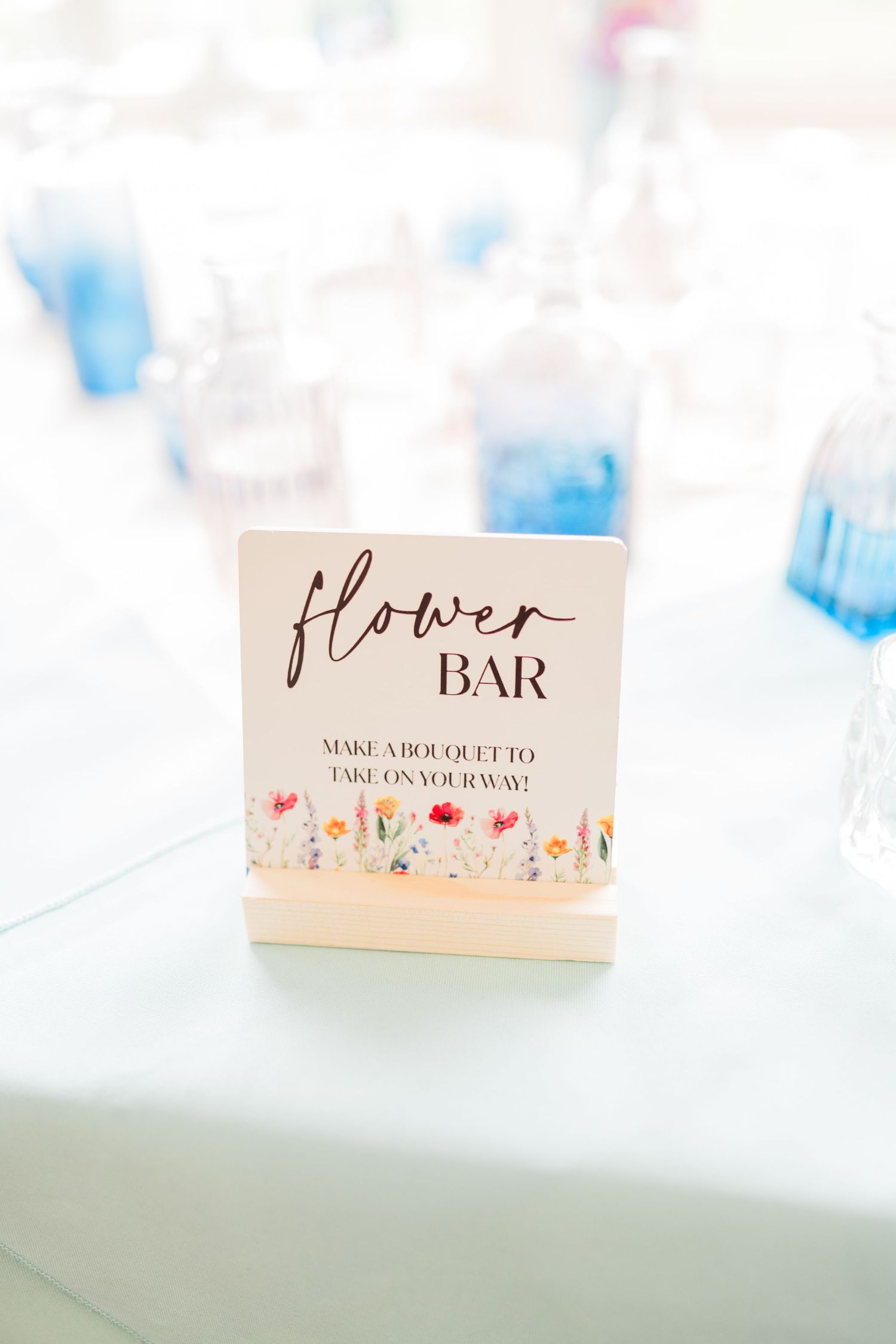 Elegant wedding signage for flower bar displayed on blush pink cards.