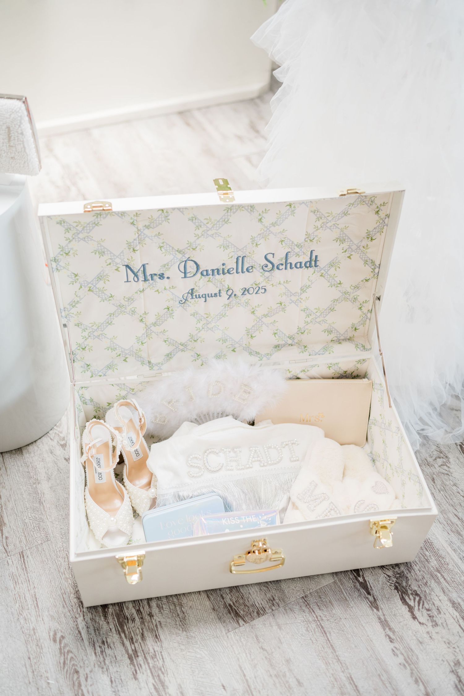 Decorative white keepsake boxes with personalized name labels and delicate floral patterns.