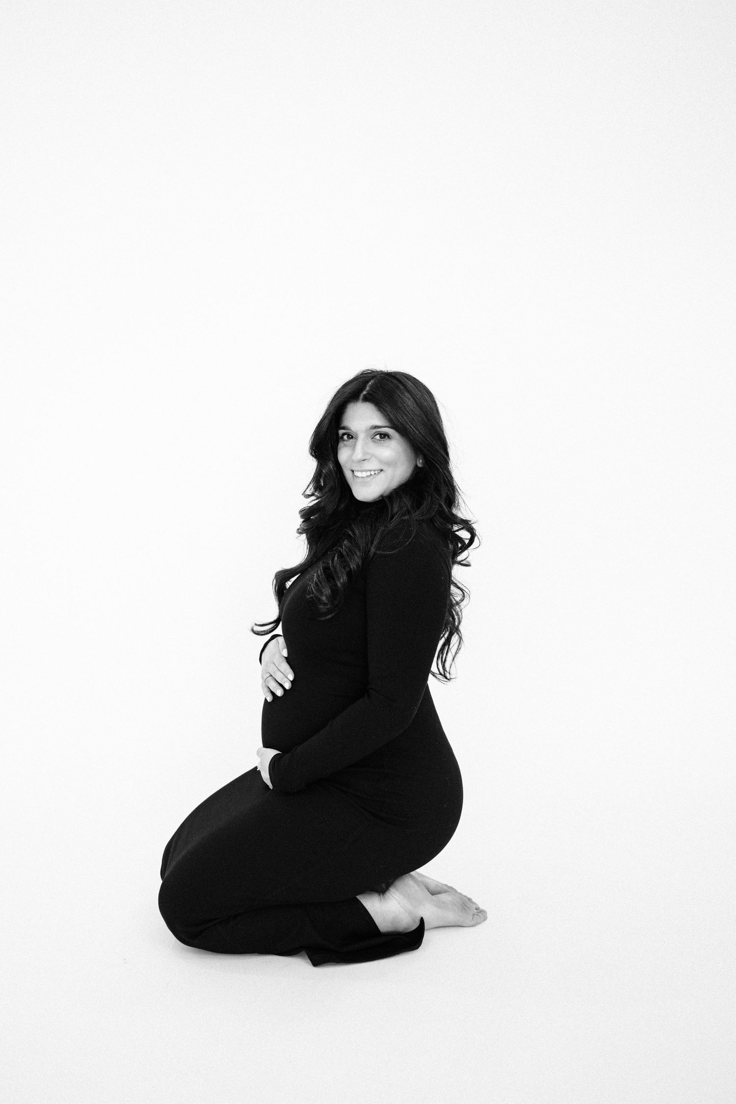 Artistic black and white maternity portraits on white background.
