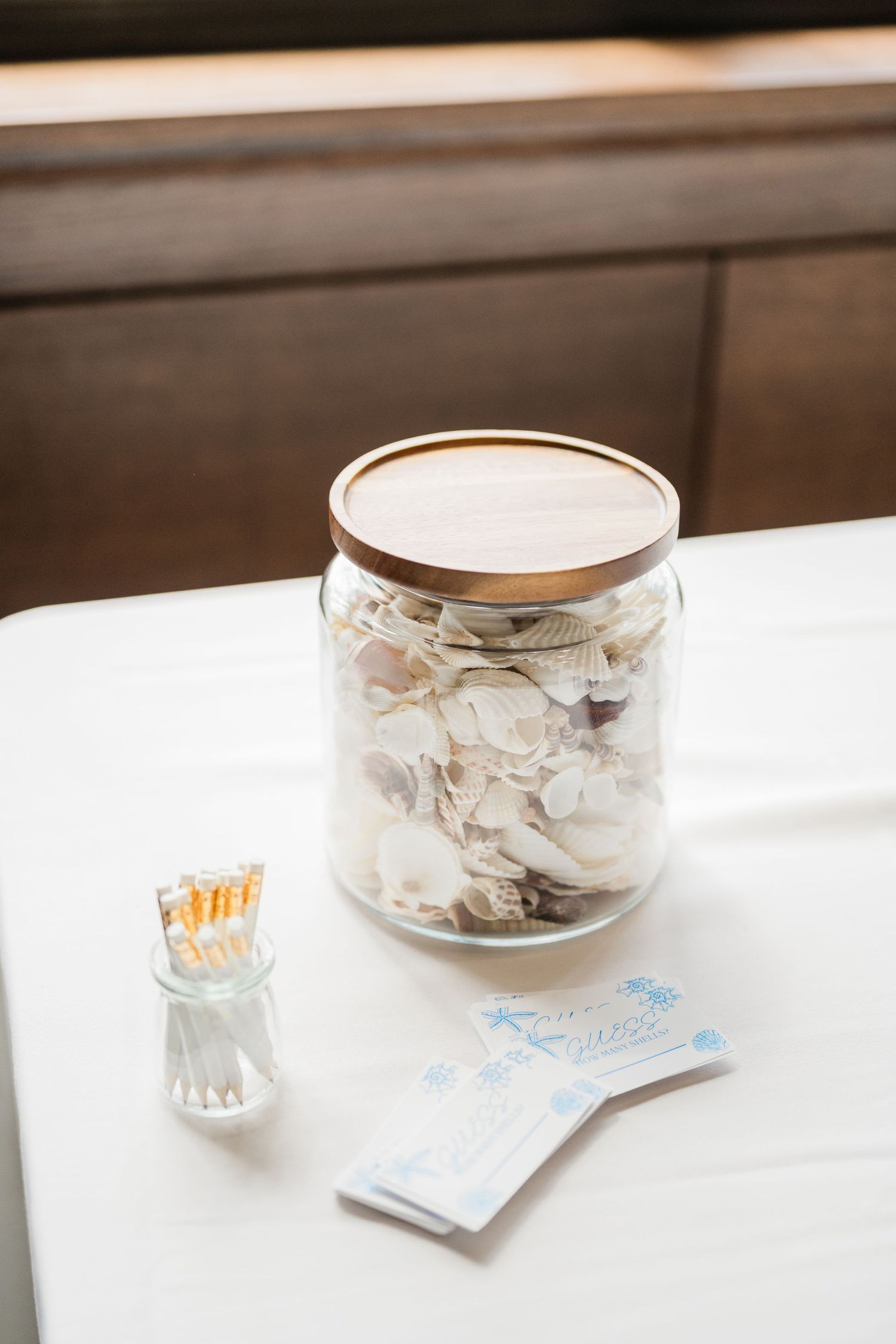 White decorative bowls and votive candles arranged on a clean table surface.