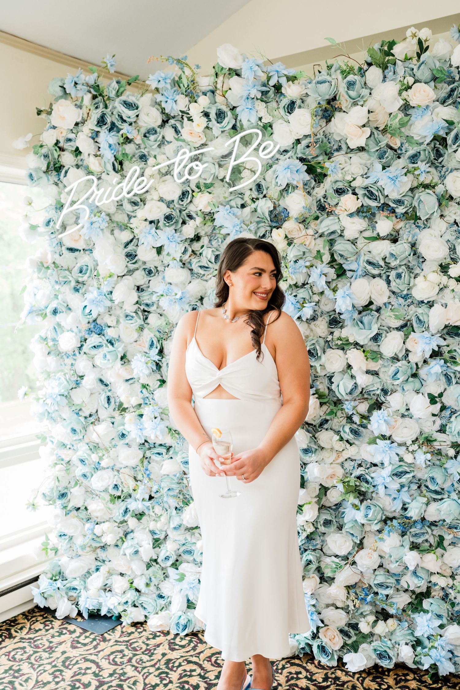 A romantic scene against a blue and white floral wall backdrop.