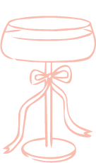 Elegant champagne coupe glass illustration with a decorative ribbon bow, drawn in soft pink outline style.
