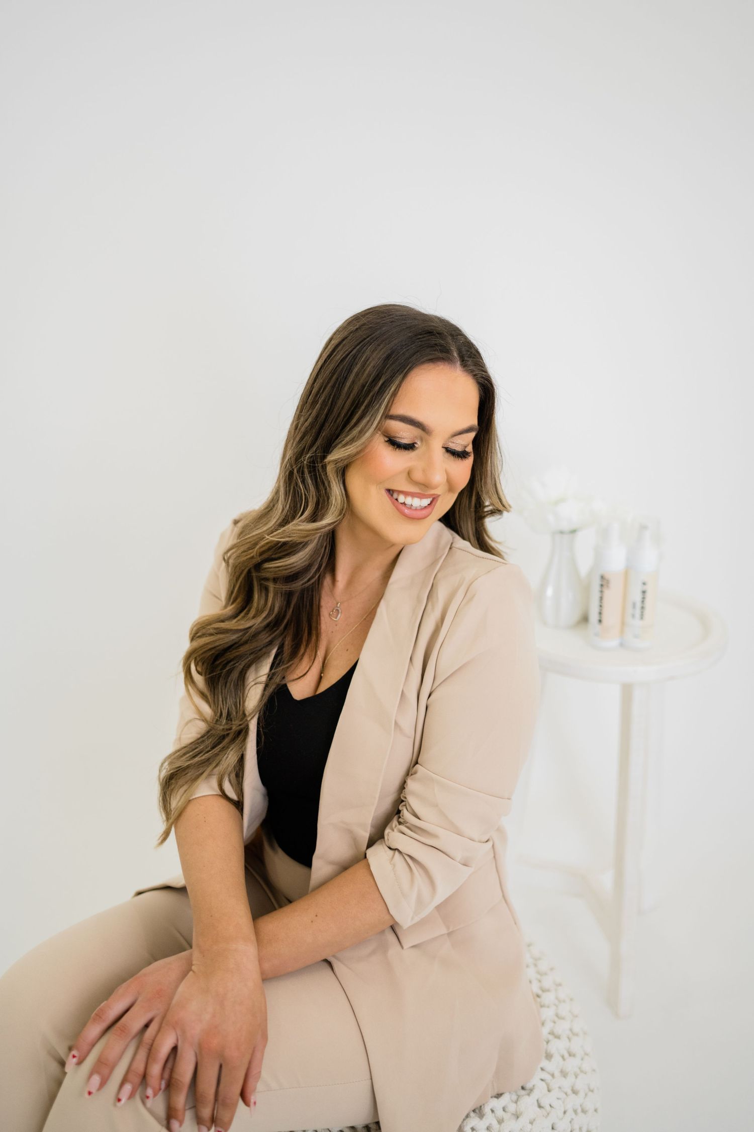 Professional lifestyle portrait session featuring a beige blazer against a white studio backdrop.