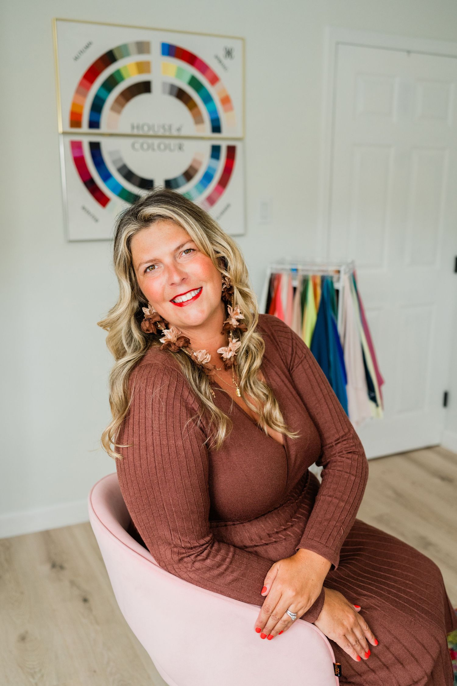 Fashion styling session with color wheels and clothing racks in bright studio setting.