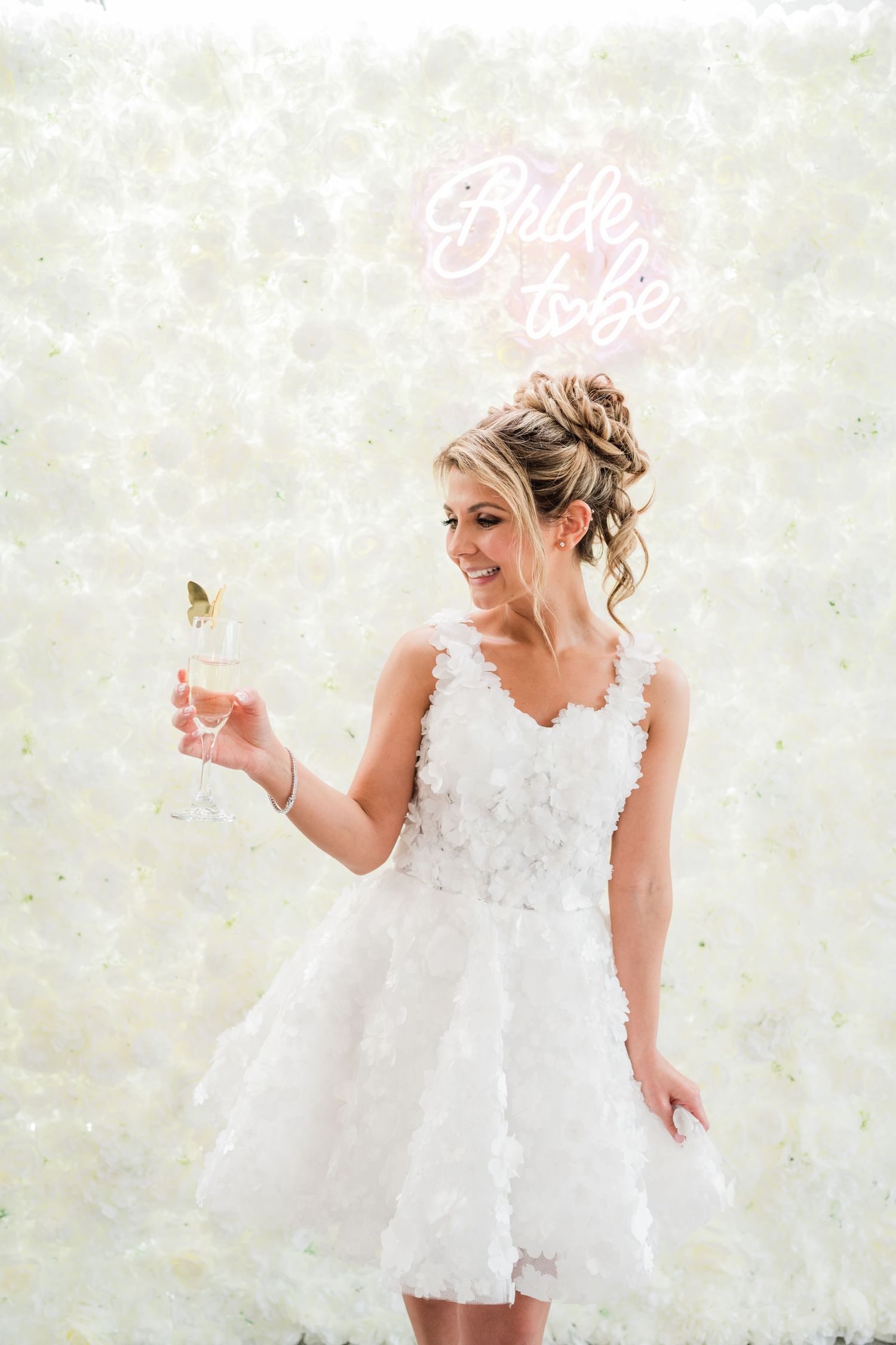 White feathered dress being showcased against a light colored backdrop.