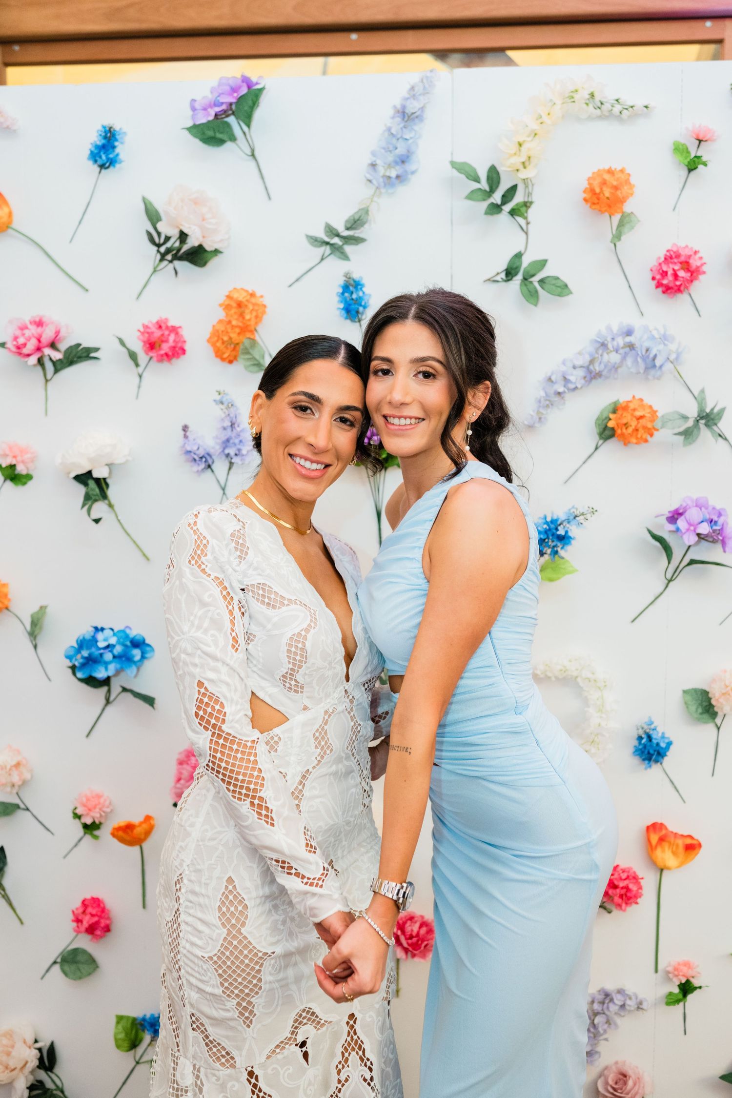 Floral backdrop with scattered colorful flowers against a light background for a special event.