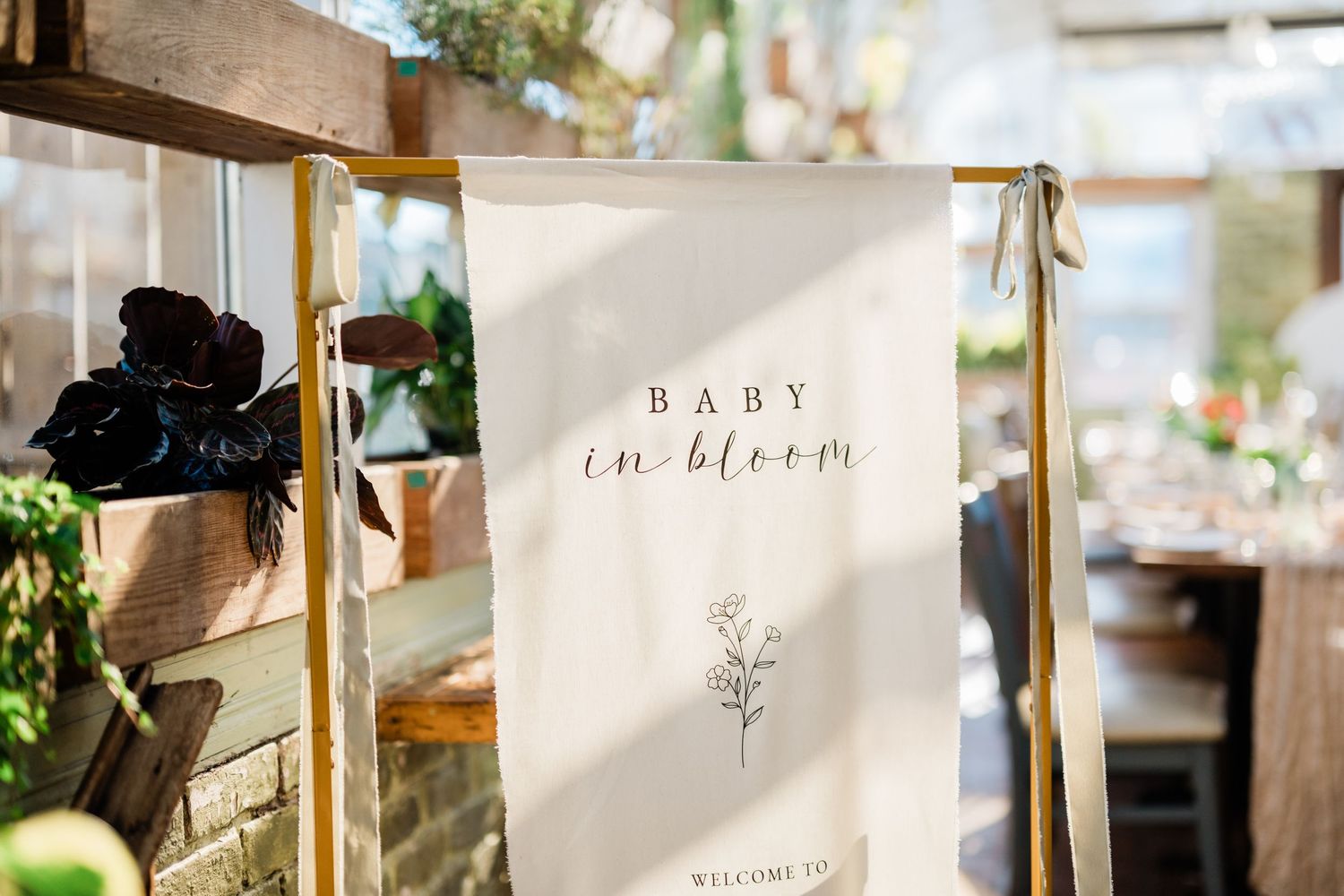 Wedding decor and signage displayed at an elegant indoor venue.