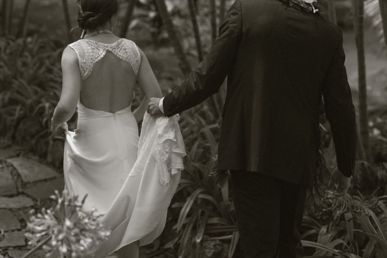 Black and white artistic photo of couple walking together outdoors in Hawaii