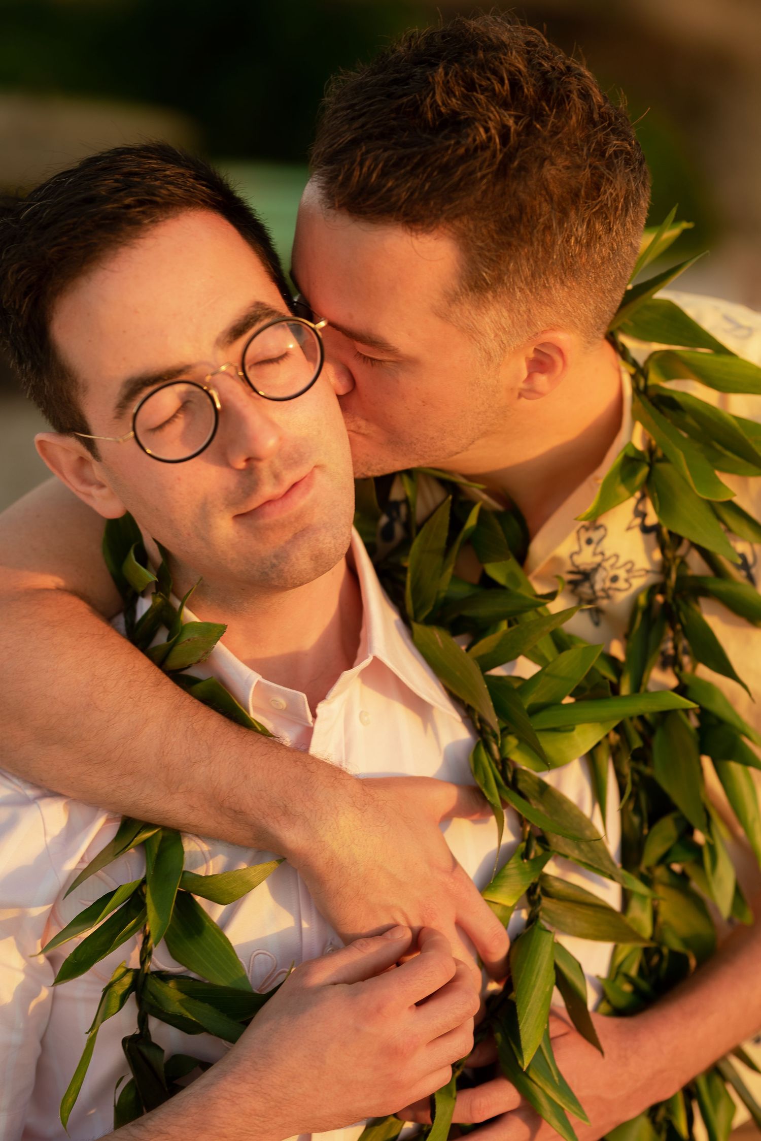 A romantic sunset moment with tropical greenery and flowers creating a warm, intimate atmosphere in Hawaii.