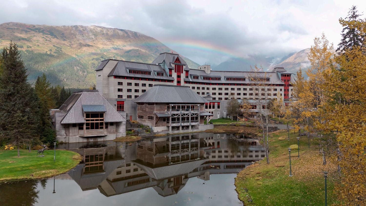 Alyeska resort in Girdwood Alaska with rainbow over the resort building in fall.