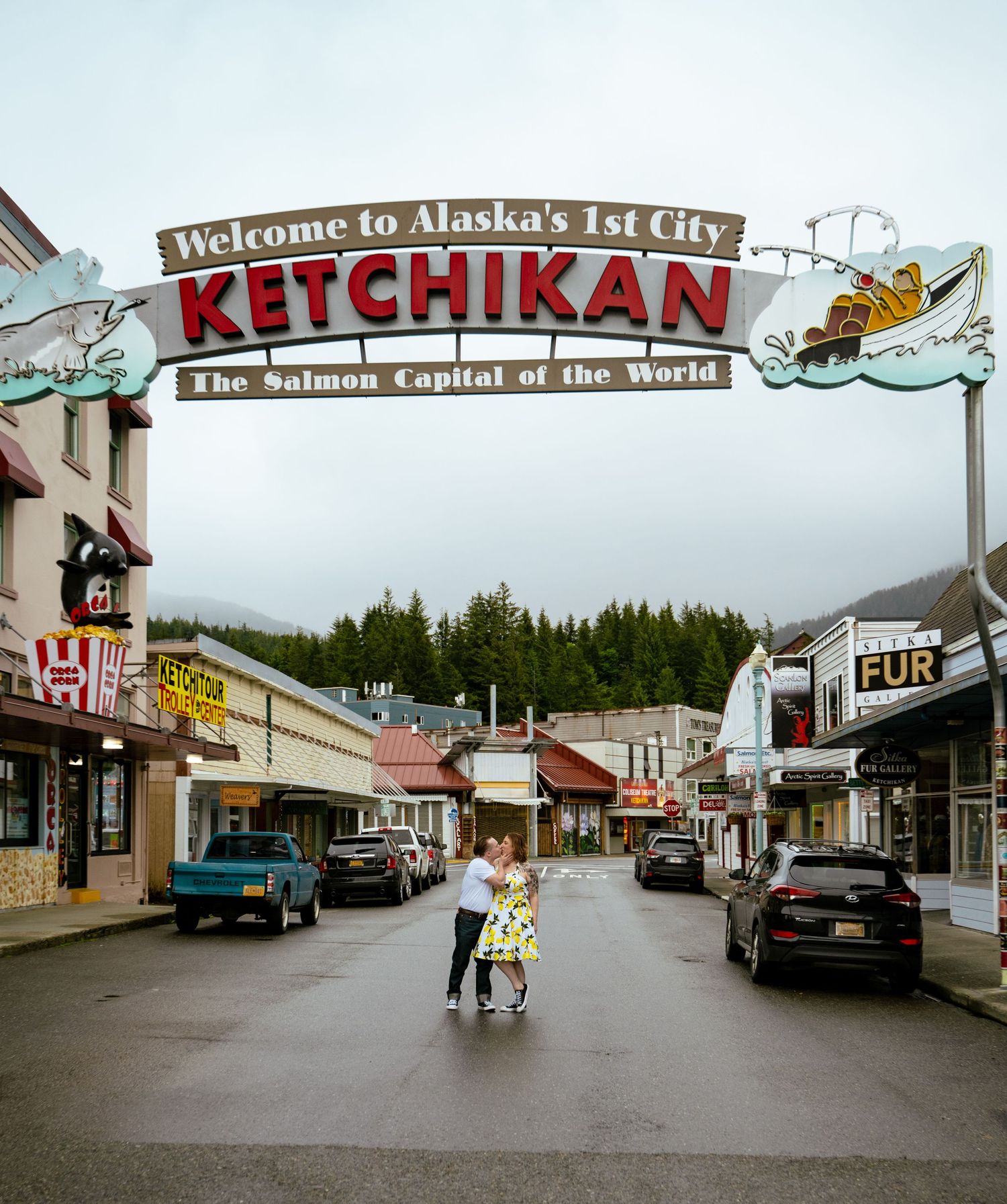 Couple Kisses under the iconic Welcome to Ketchikan Alaska's 1st City Salmon Capital of the World arch sign.