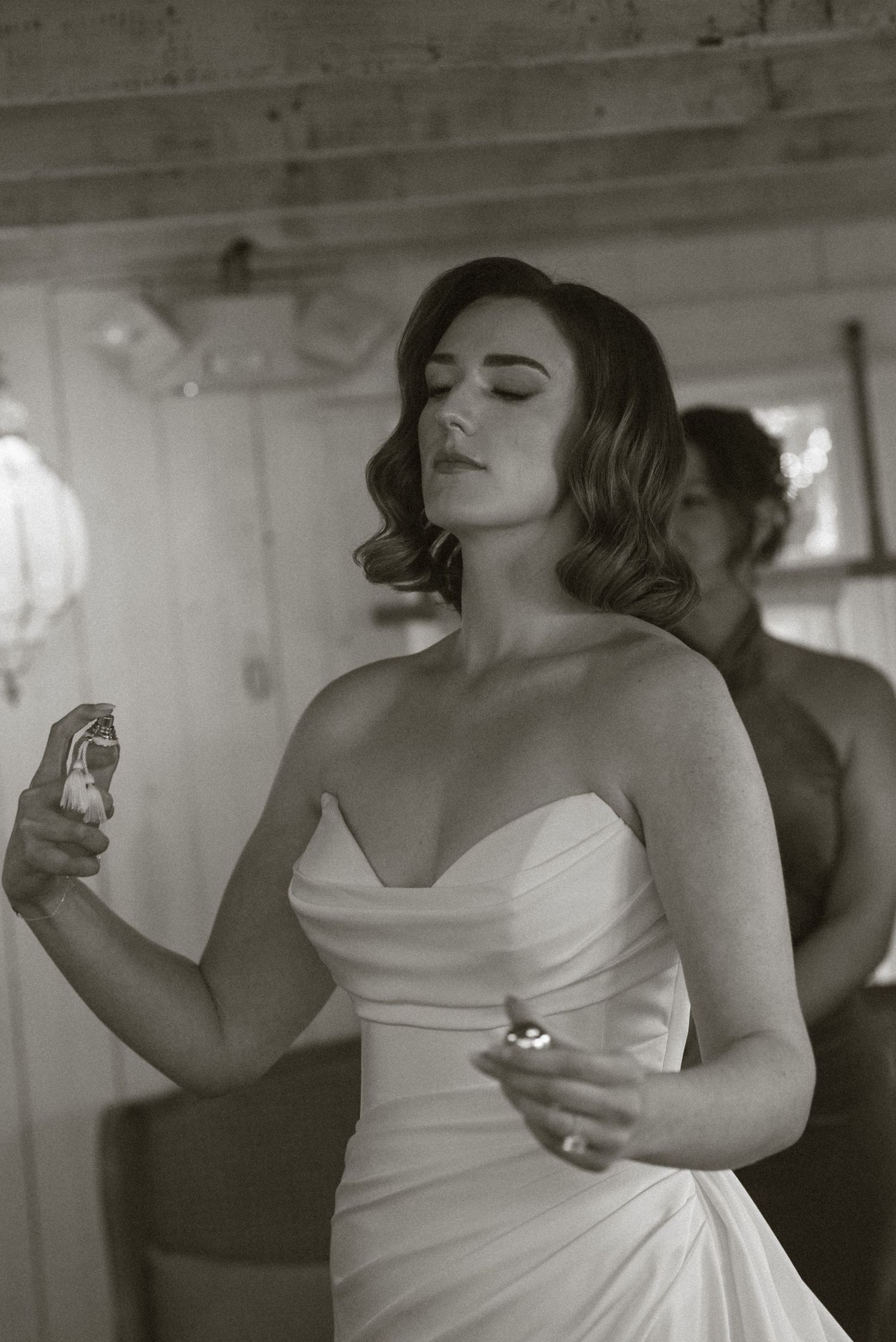 A series of black and white photos showing someone in a white dress taking a celebratory drink at a wedding reception.