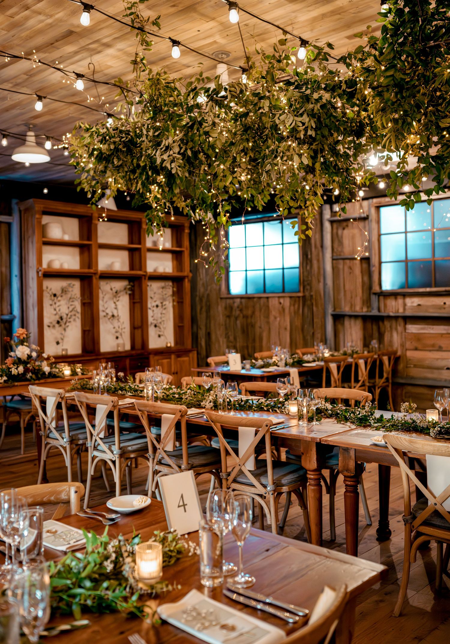 Rustic and curated reception space decorated in green drapery at Terrain at Styers Wedding Venue