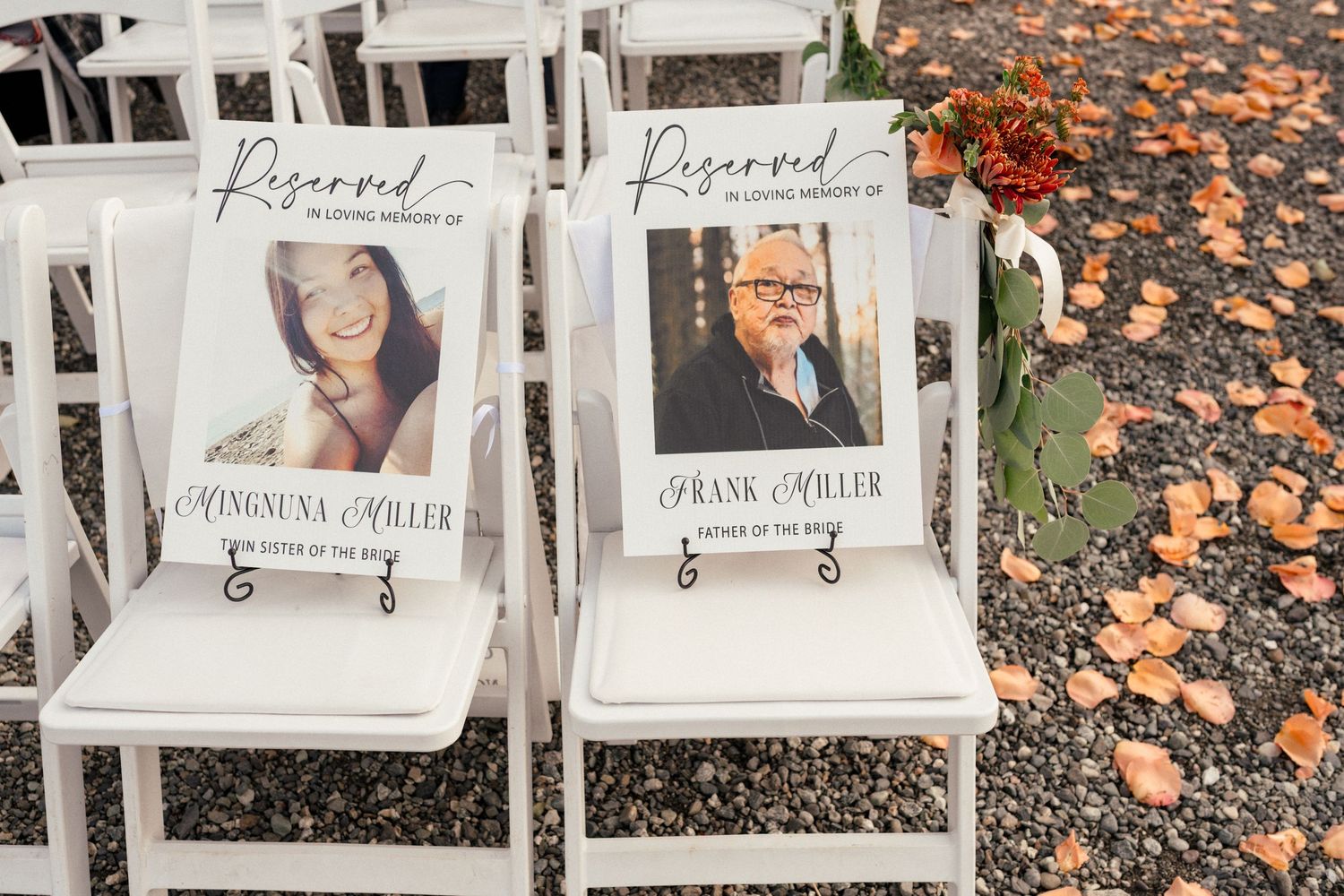 Reserved wedding chairs with memorial signs honoring Himauna Miller and Frank Miller placed at an outdoor ceremony.