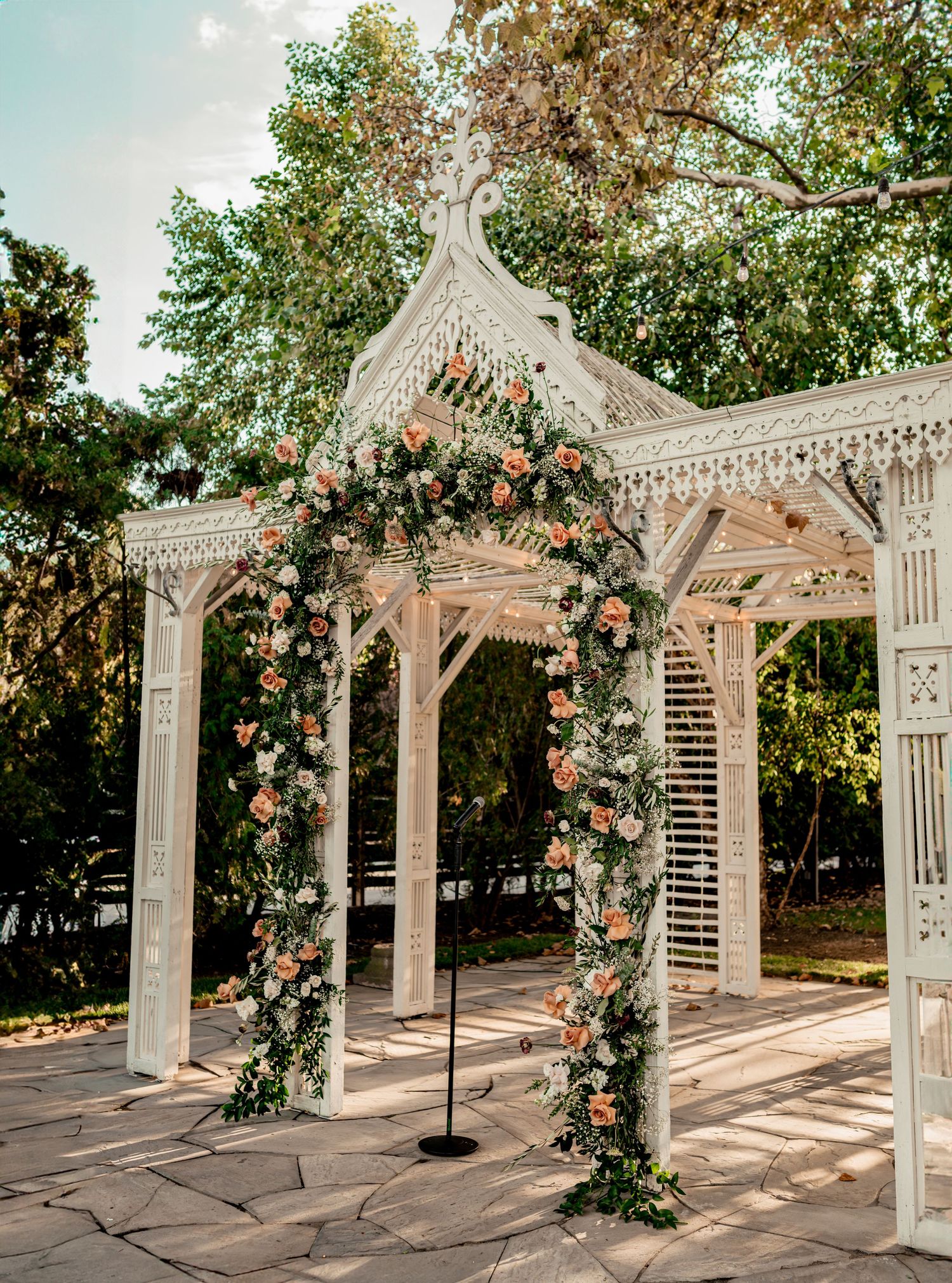 Luxury rose floral arrangement on white gazebo at Terrain at Styers wedding venue in Glenn mills PA