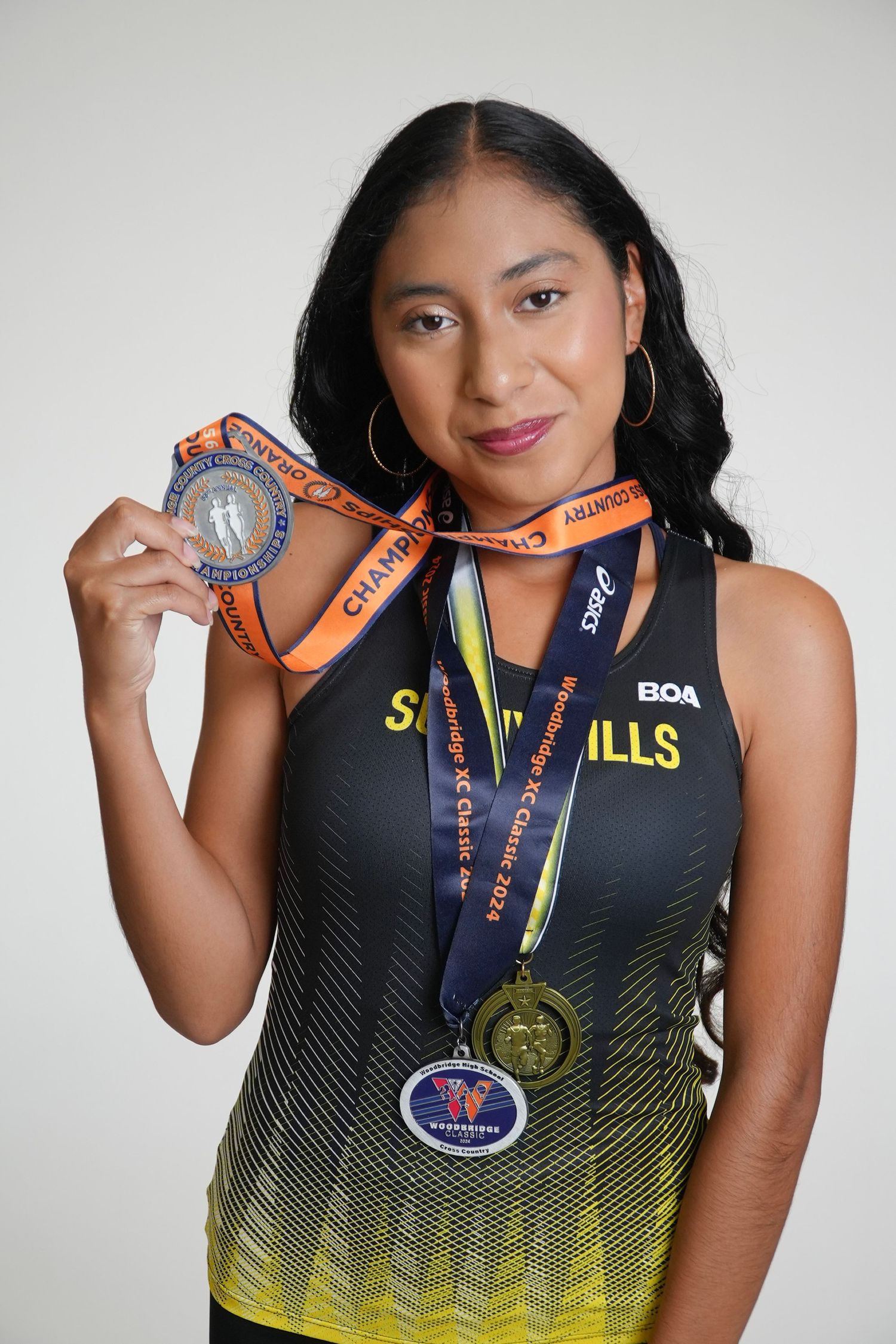 Female high school athlete posing for a sports team portrait in Fullerton, CA.