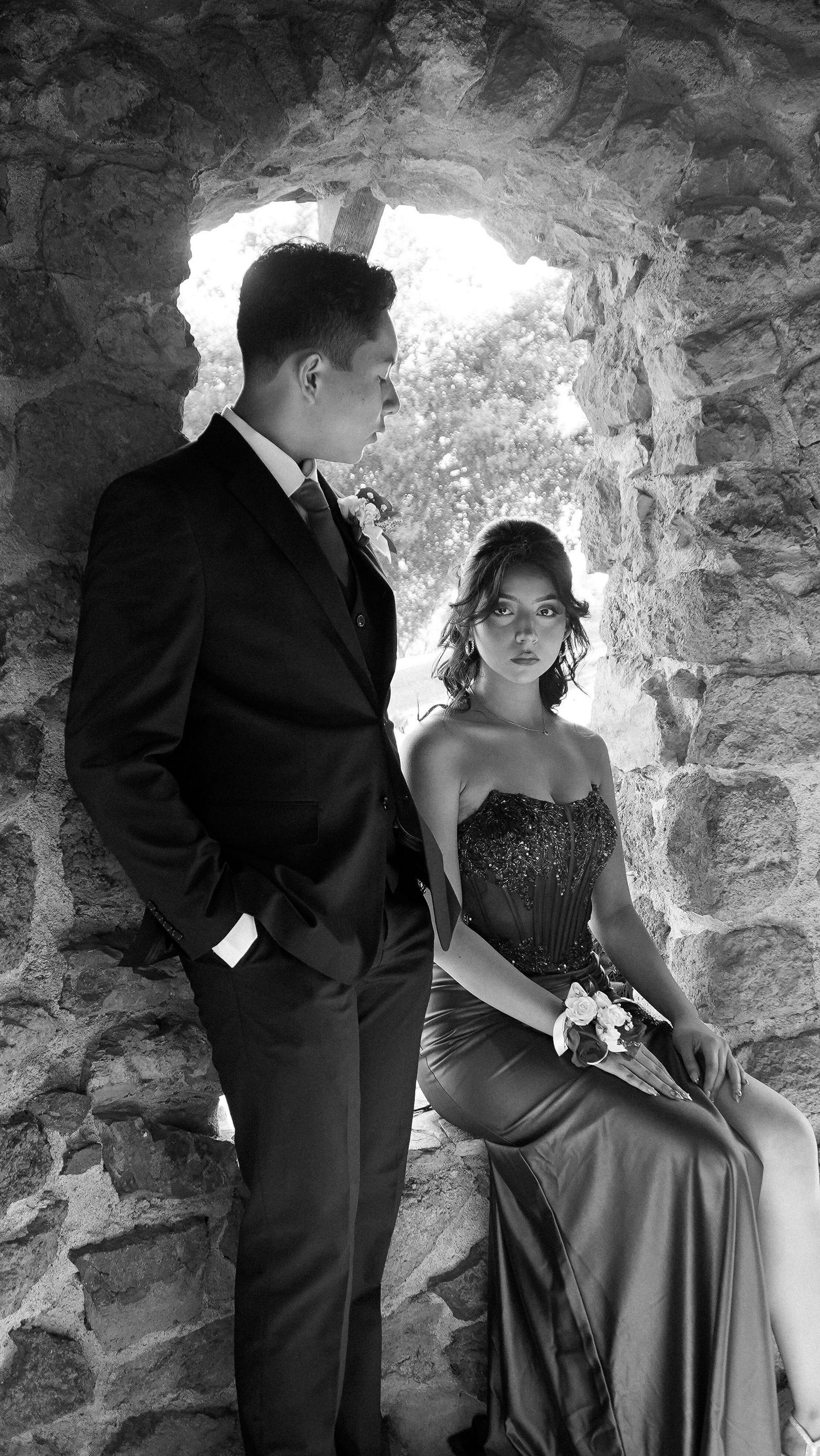 Prom couple posing in a stone archway at Muckenthaler Mansion in Fullerton, CA.