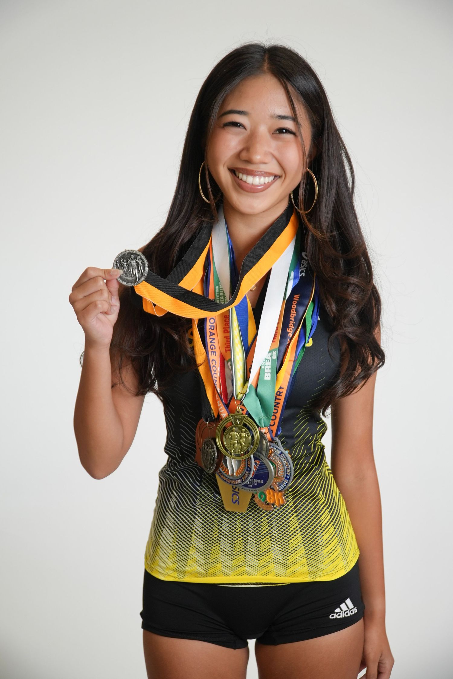 Female high school athlete posing for a sports team portrait in Fullerton, CA.