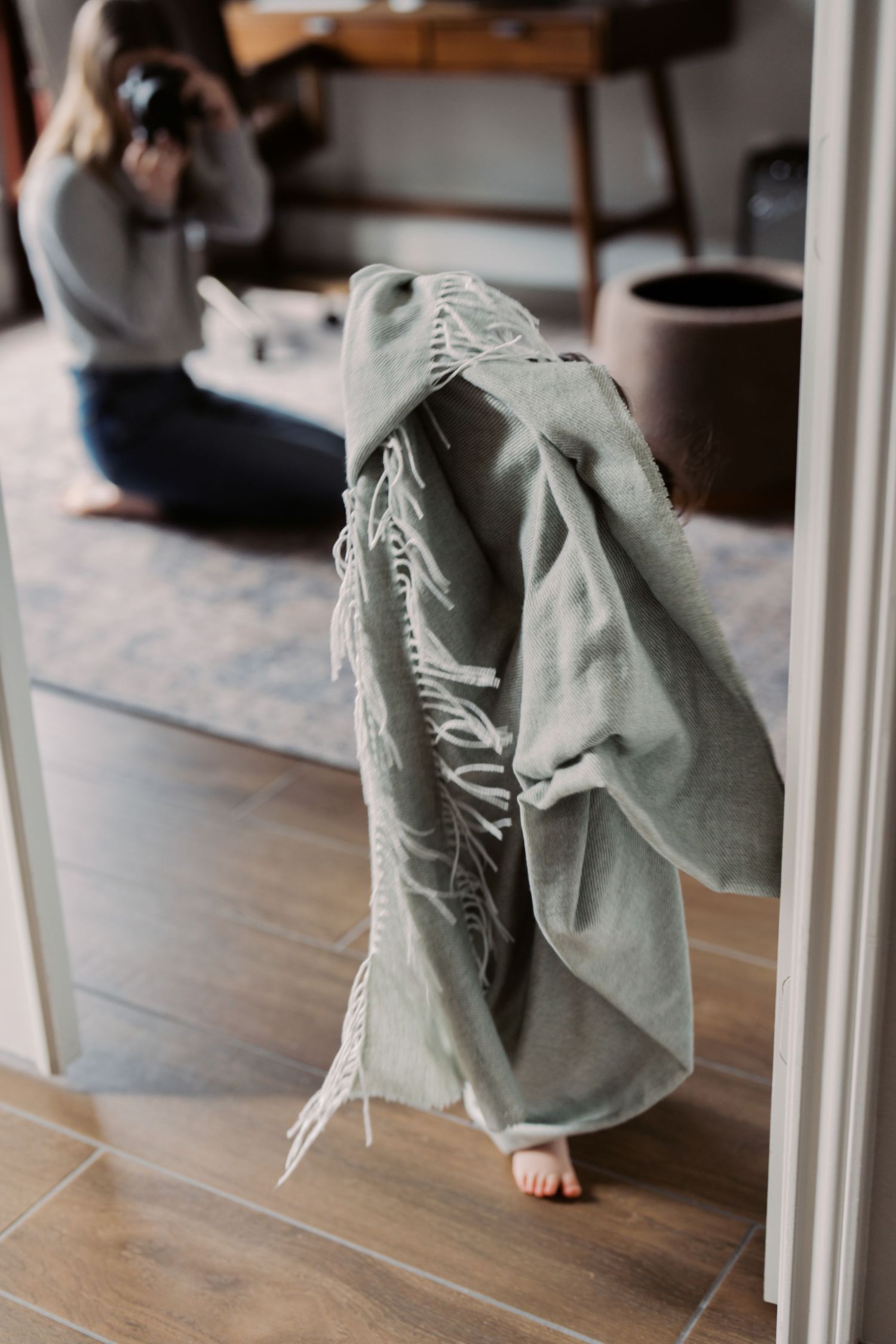 A person wearing a gray hooded robe or cloak is visible in the image.