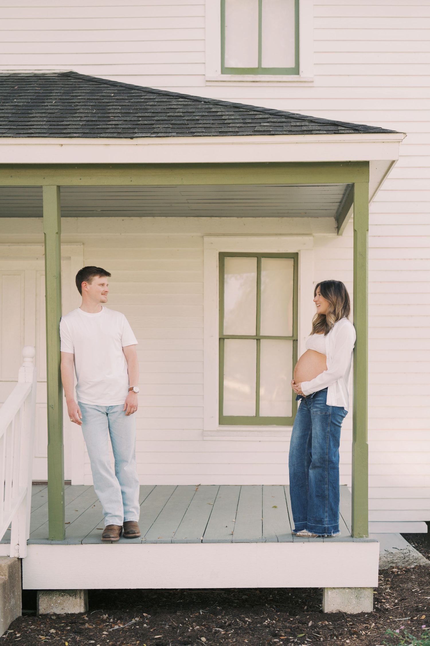 A minimalist photo series showing people sitting and standing on a white porch with green trim in casual attire.