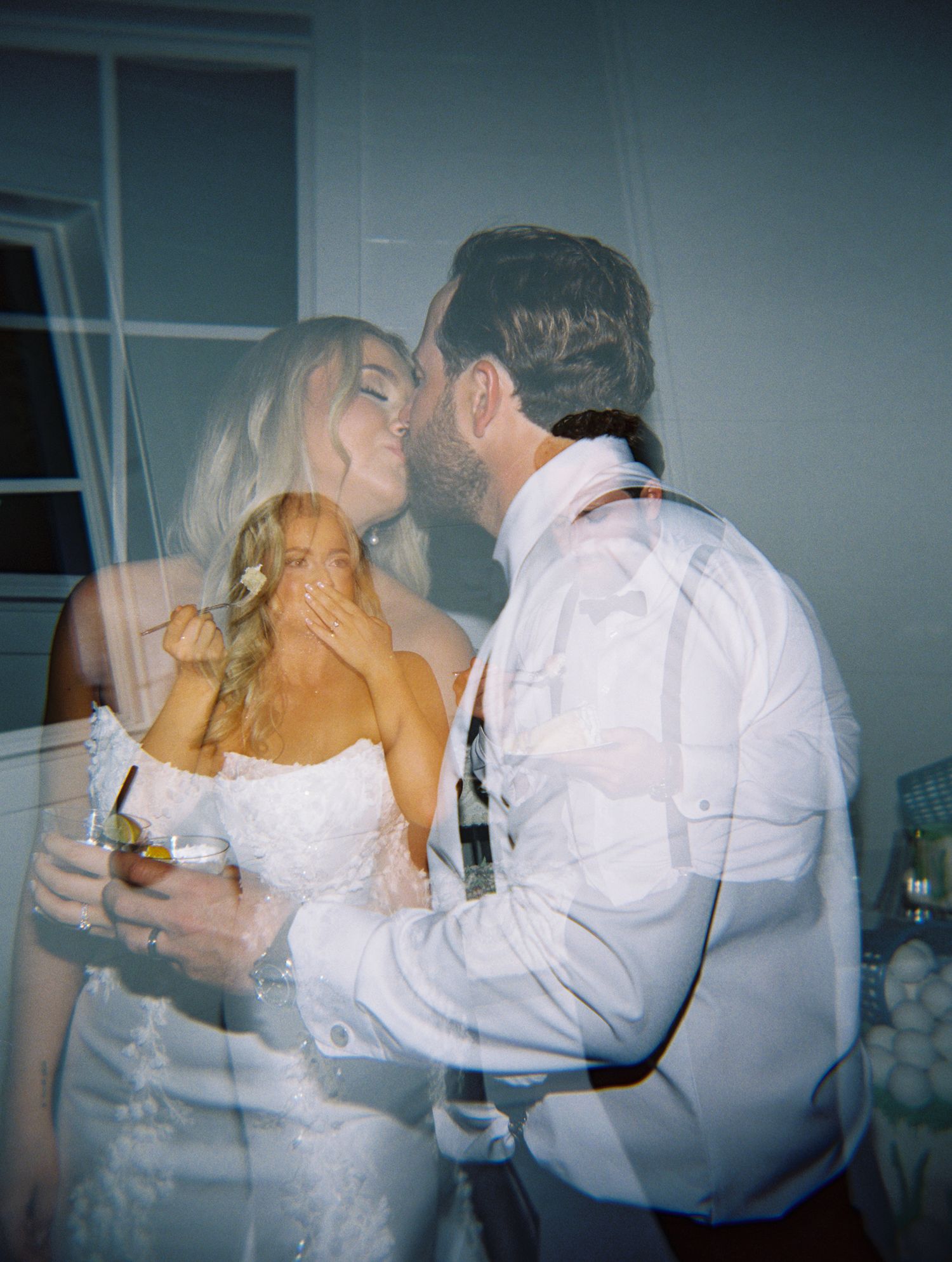 Double exposure film photo of a bride and groom sharing a romantic kiss at their wedding reception.