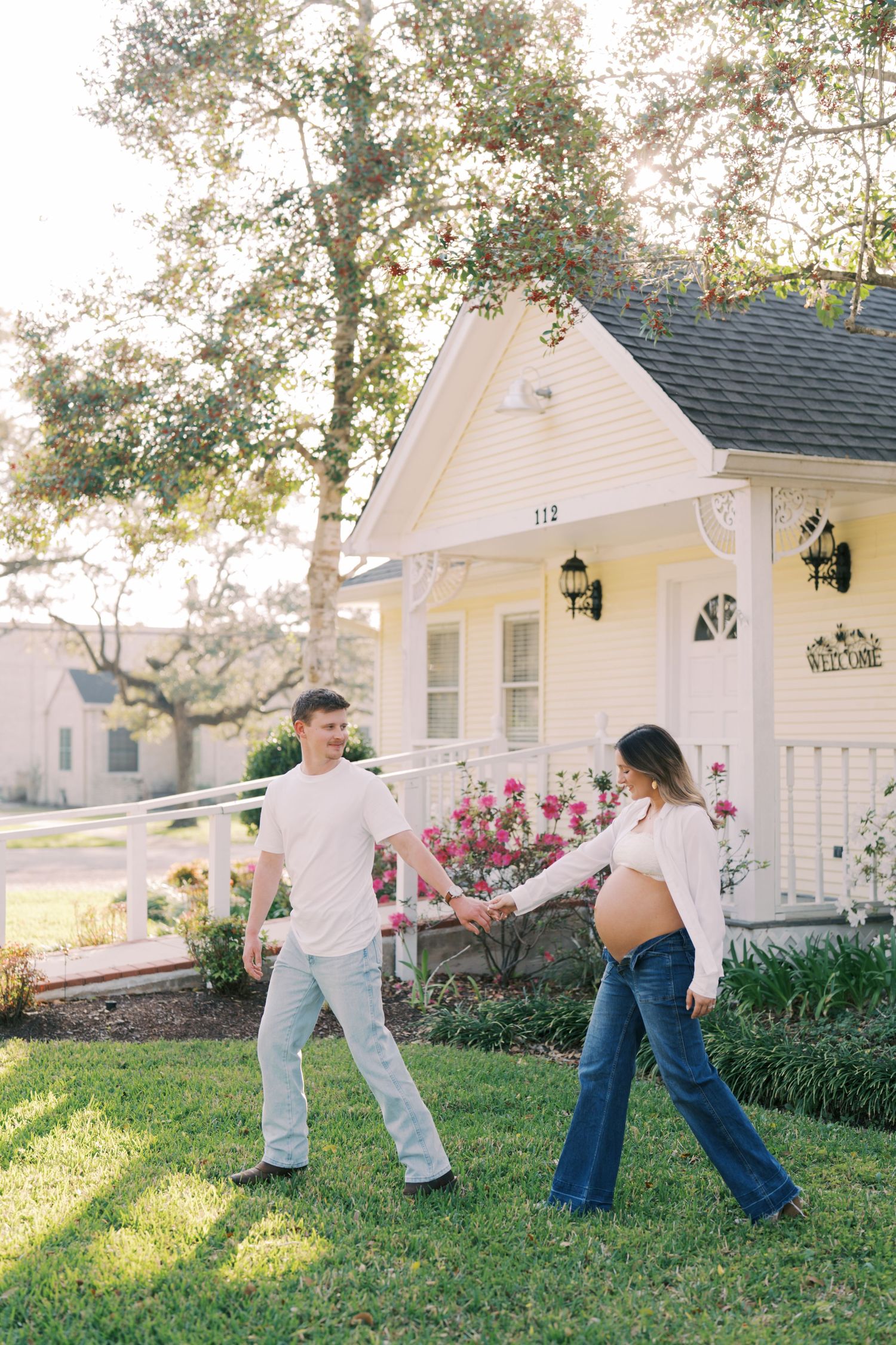 A playful sequence of images showing two people dancing and twirling on a sunny lawn in front of a white house.